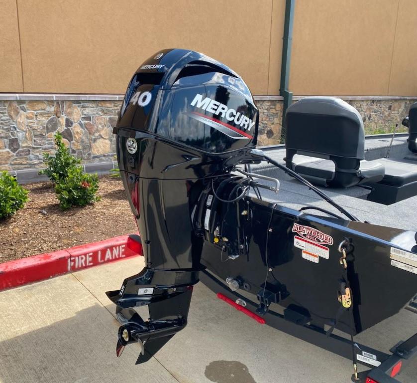 2025 Tracker Panfish 17 boat with Mercury outboard motor in a parking area.