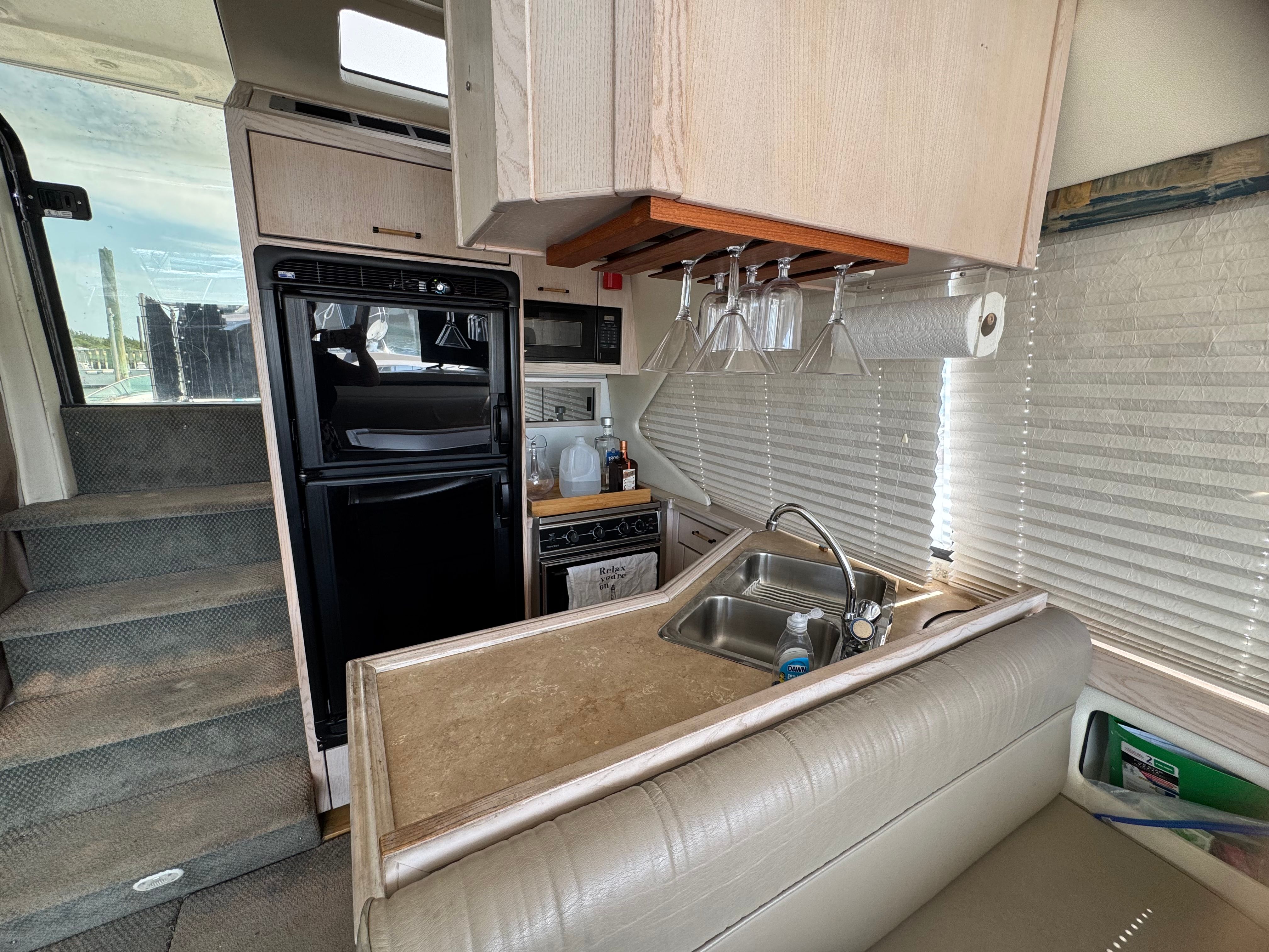 Interior of Bayliner 3587 yacht with kitchen and seating area.
