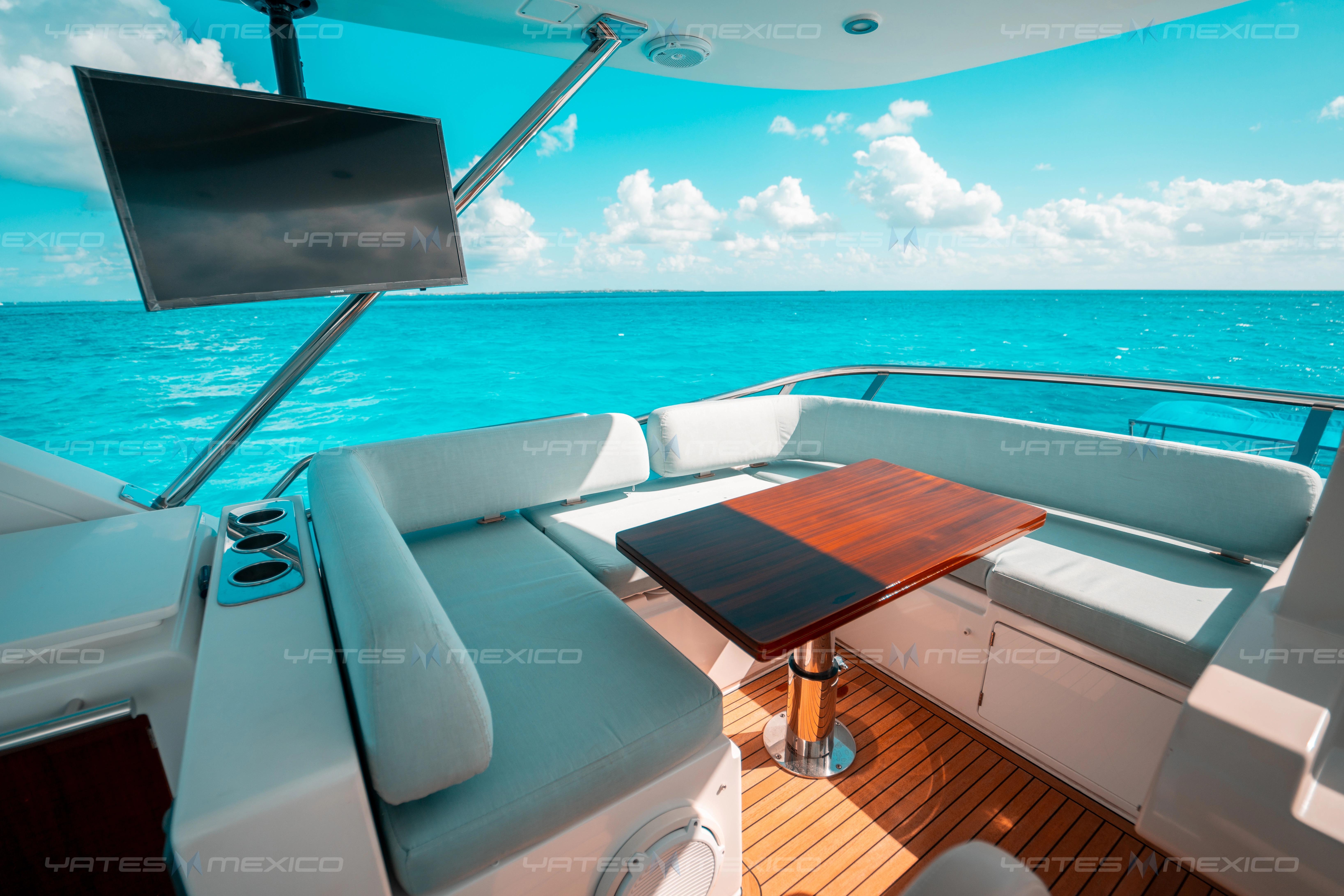 Luxurious 2017 Azimut 66 yacht deck with seating, table, and ocean view.