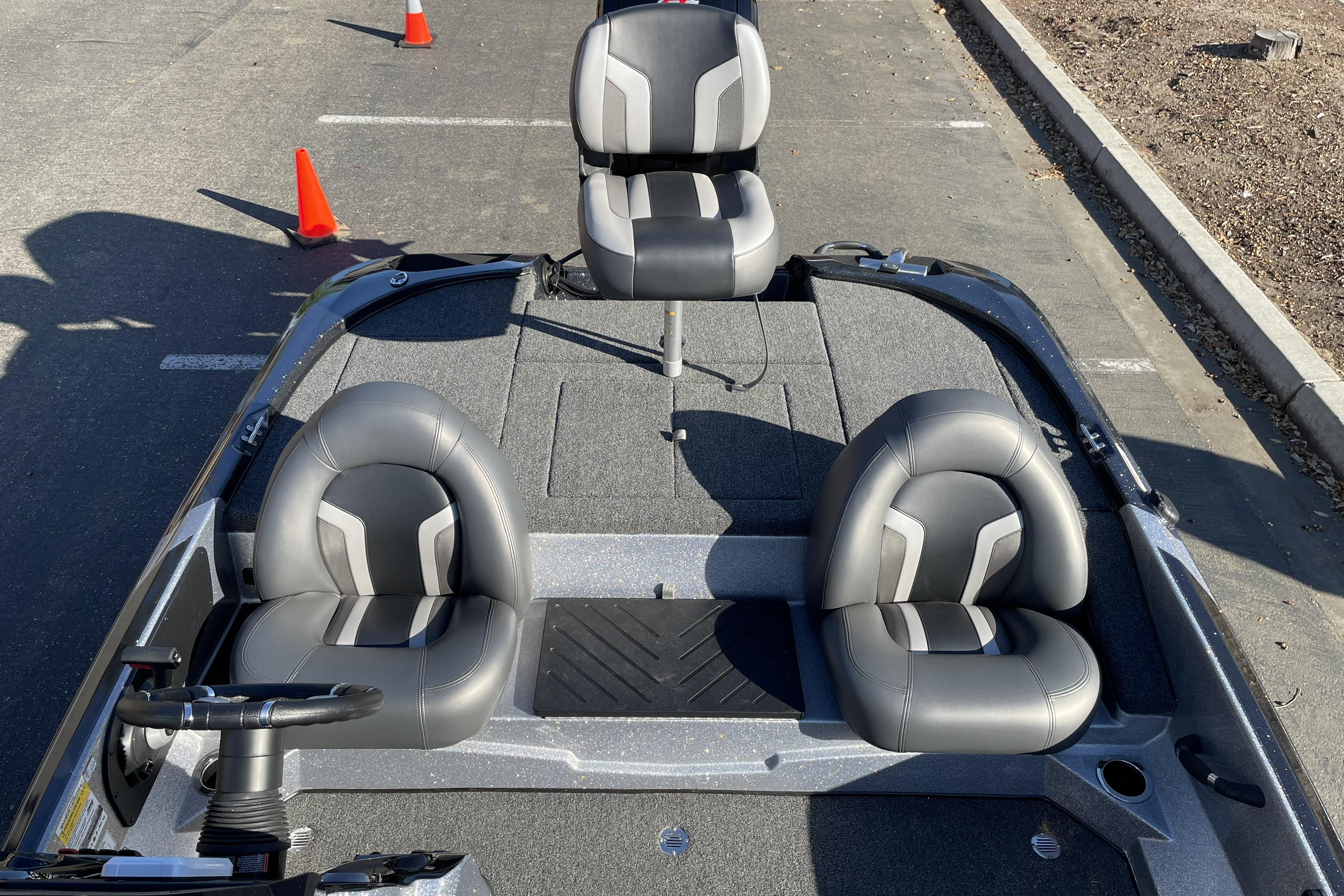 2026 Nitro Z17 boat interior with three gray seats and steering wheel on a sunny day.
