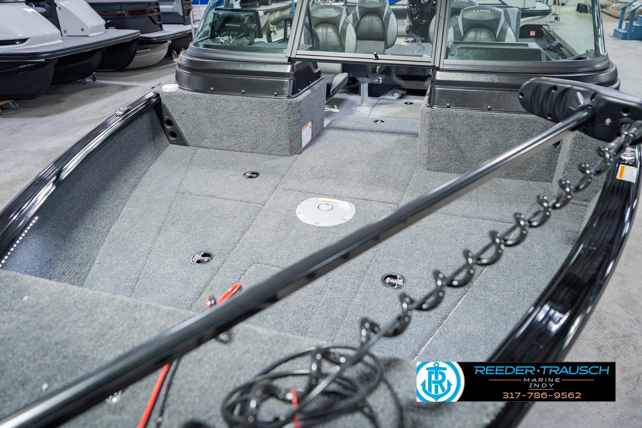 2026 Lund 1775 Impact XS boat interior with carpeted deck and seating.