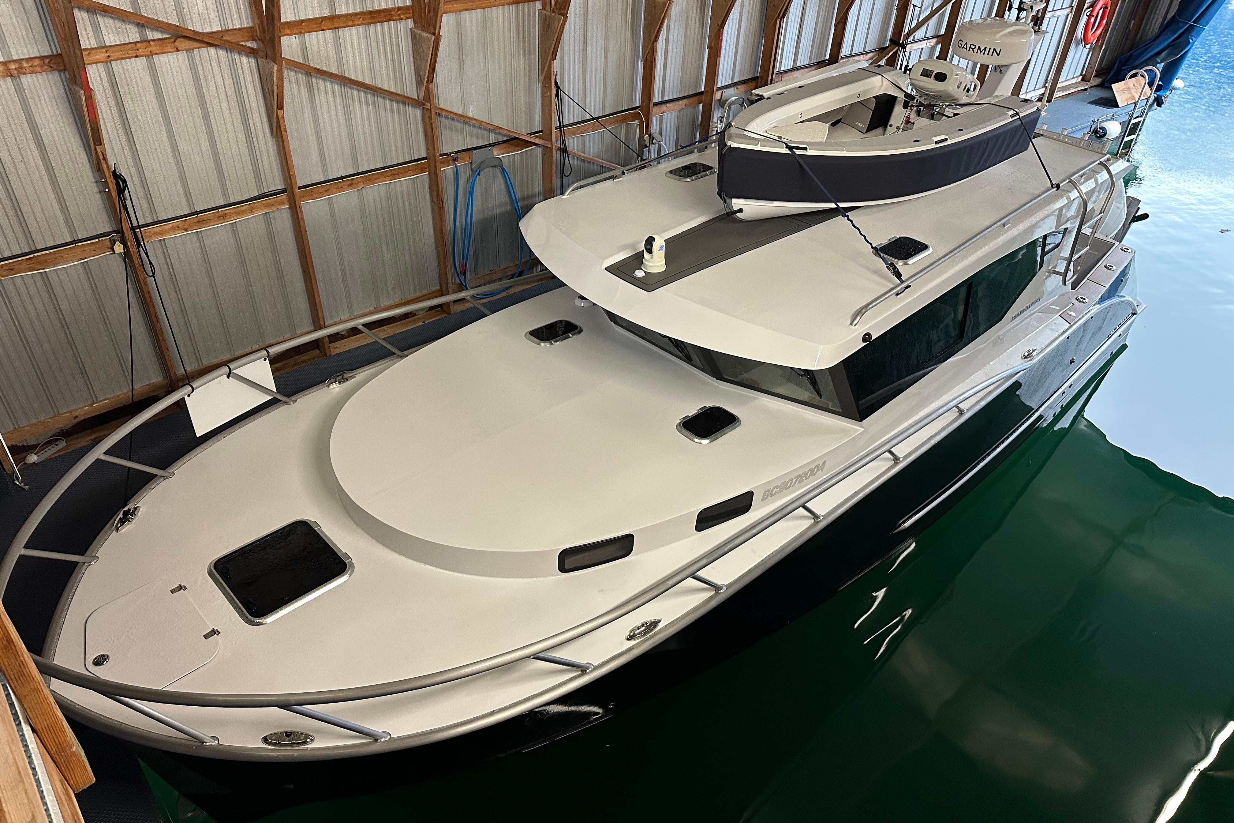 2024 Herley 11 Explorer boat docked in a wooden boathouse.