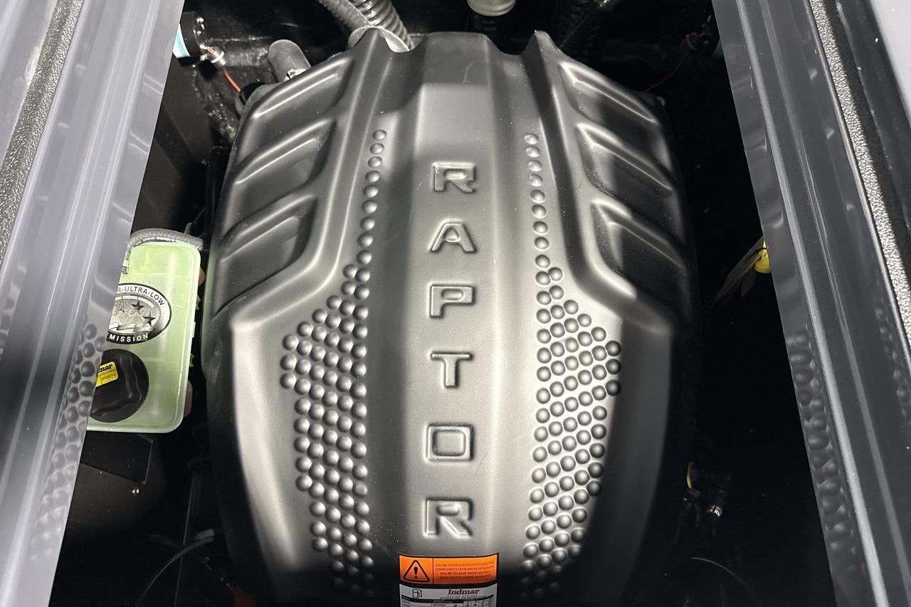 Engine cover with "Raptor" branding in a Moomba Craz boat.