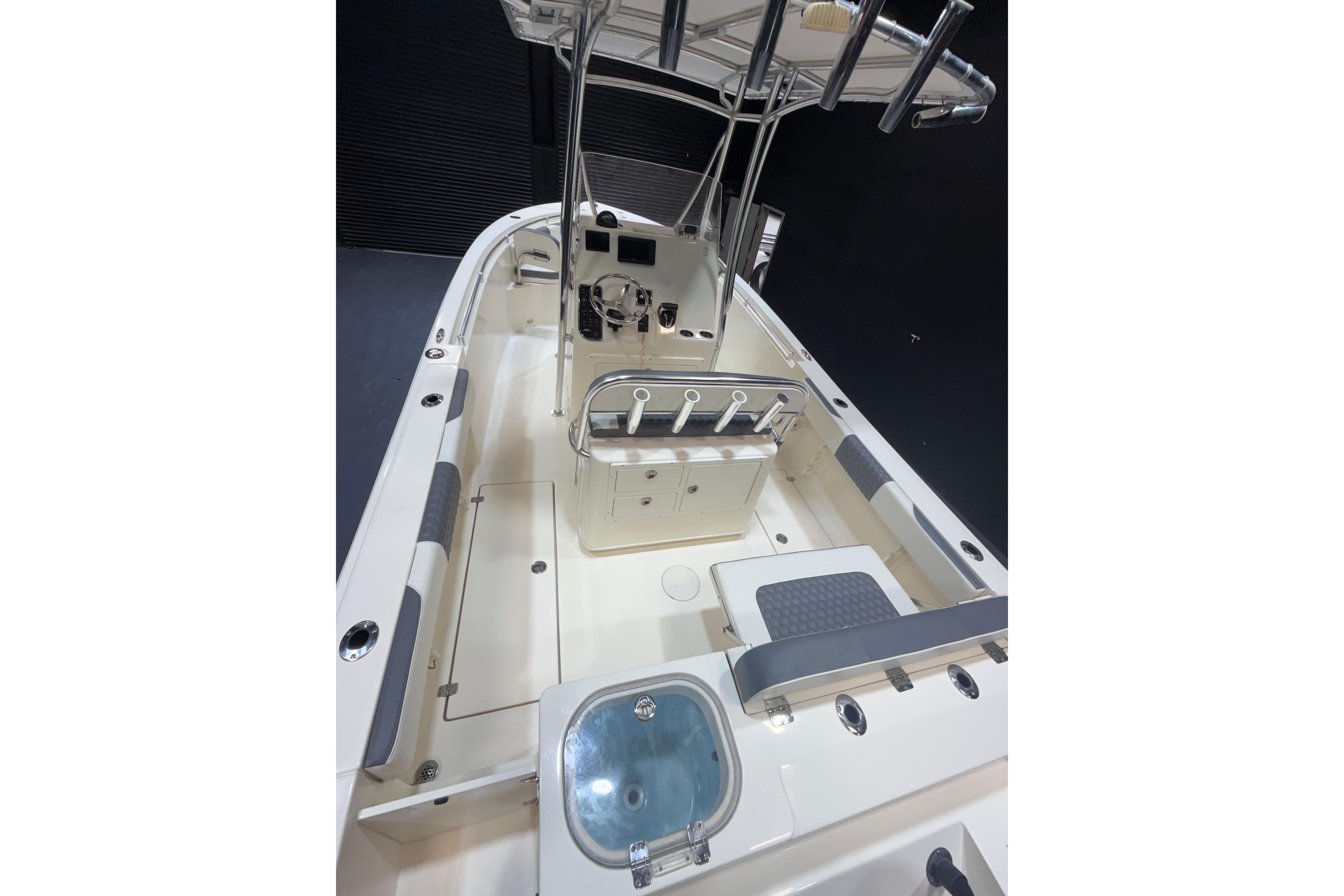 2023 Cobia 237 Center Console boat interior with helm, seating, and rod holders.