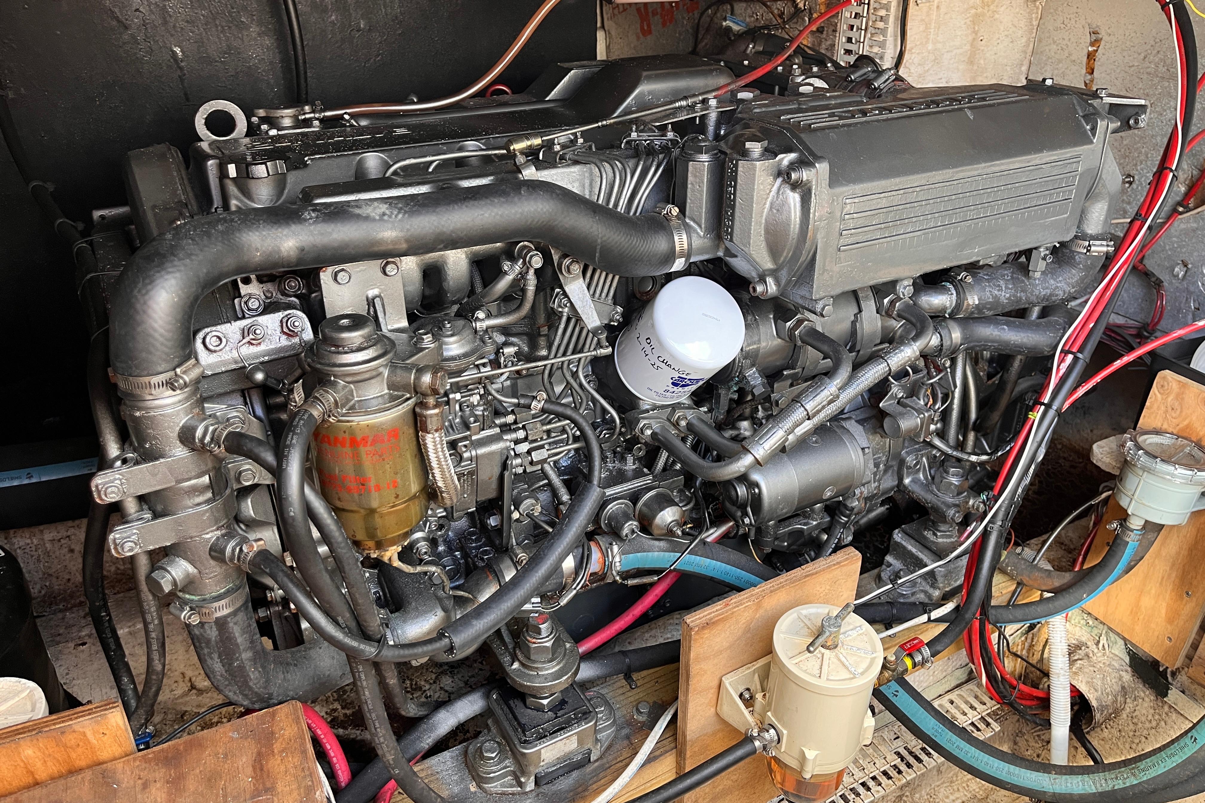 Engine of a 1972 Whitcraft houseboat, showcasing intricate mechanical components and wiring.