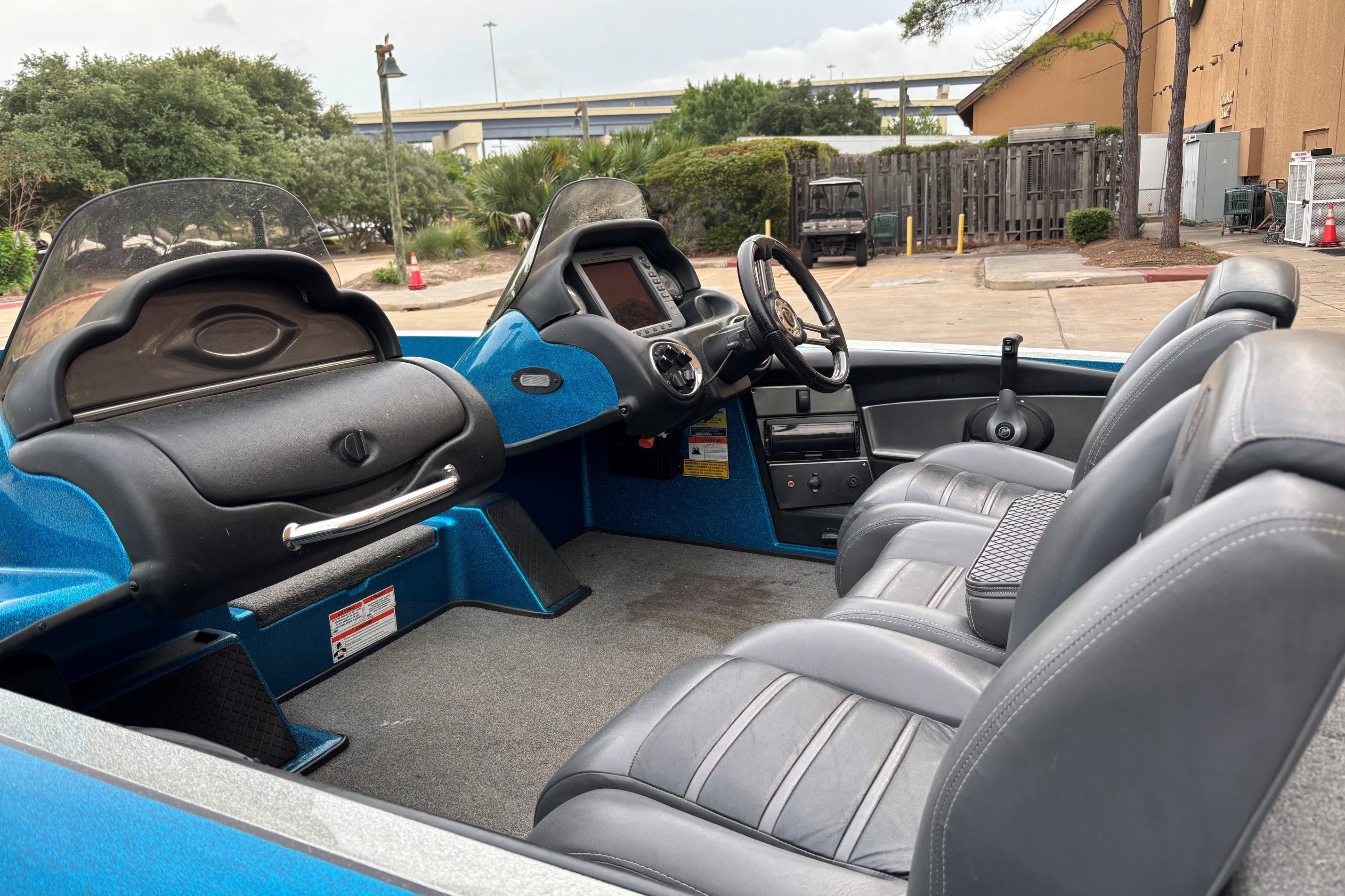 2009 Triton 22 TrX boat interior with gray seats and dual consoles.