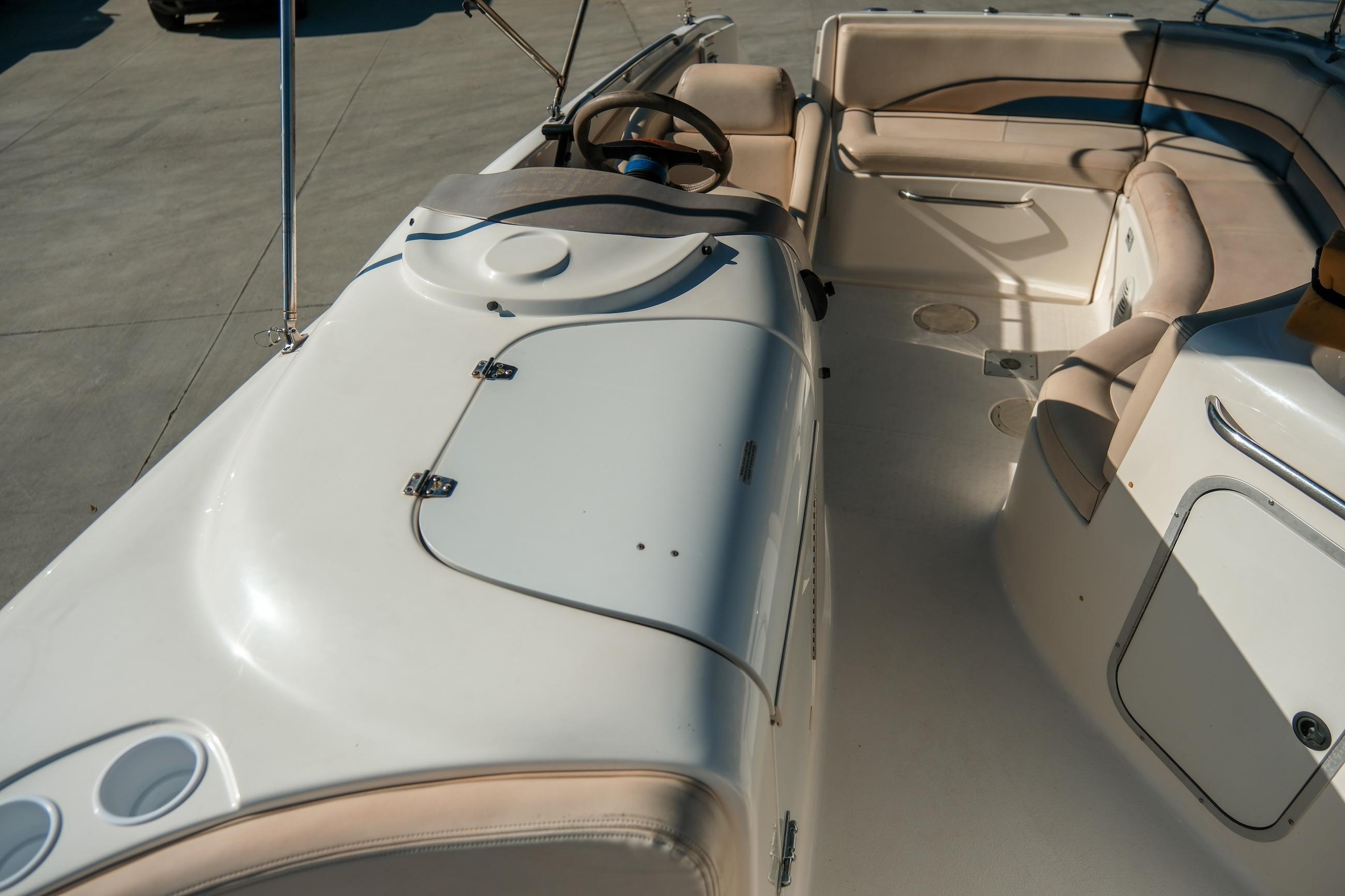 1998 Chaparral 232 Sunesta boat interior with beige seating and steering wheel.