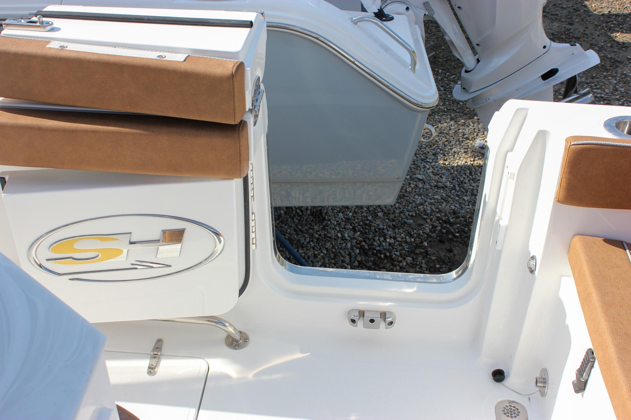 2027 Sea Hunt Ultra 275 SE boat interior with brown seating and open hatch.