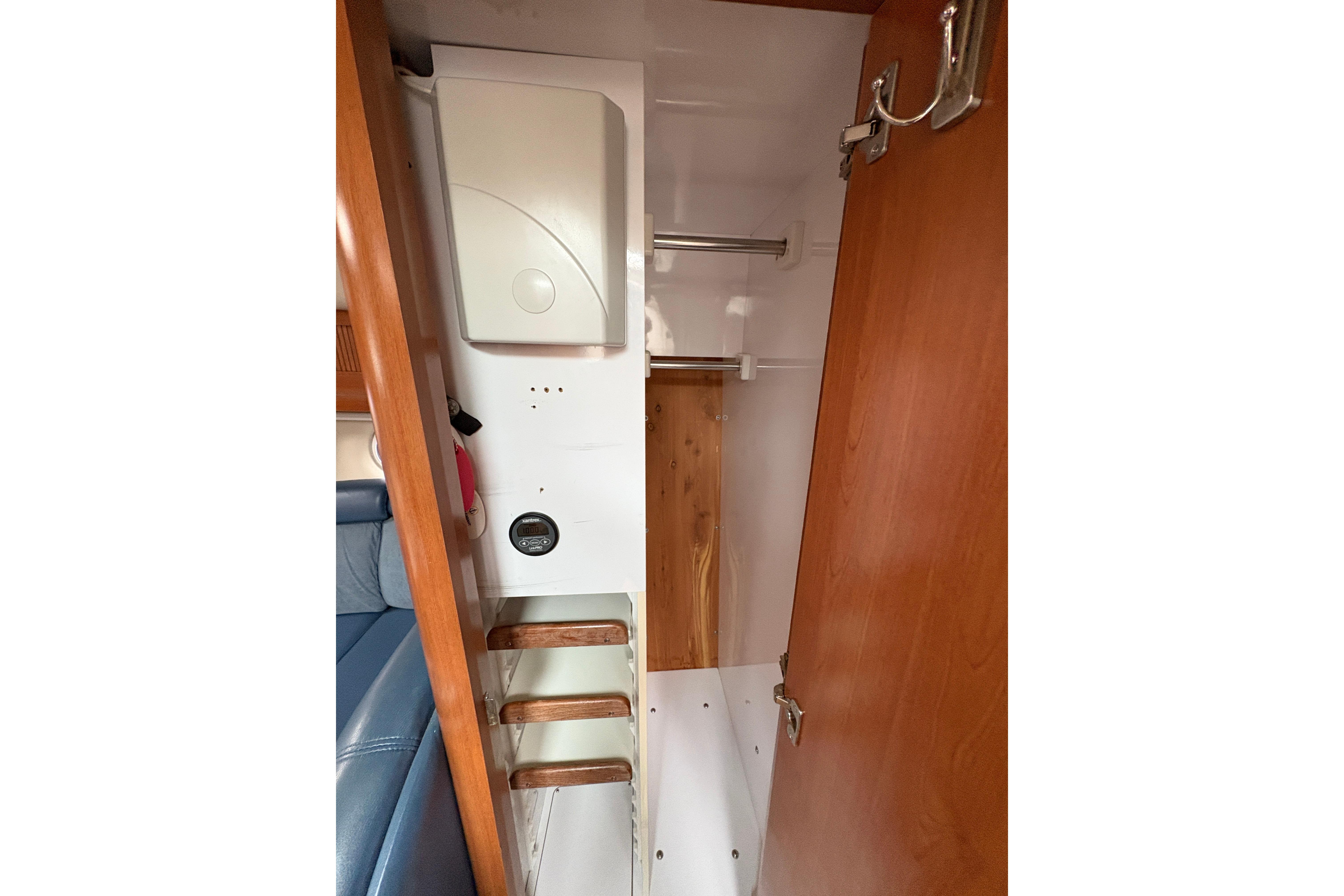 Interior storage space of 2002 Four Winns 328 Vista boat with wooden accents.