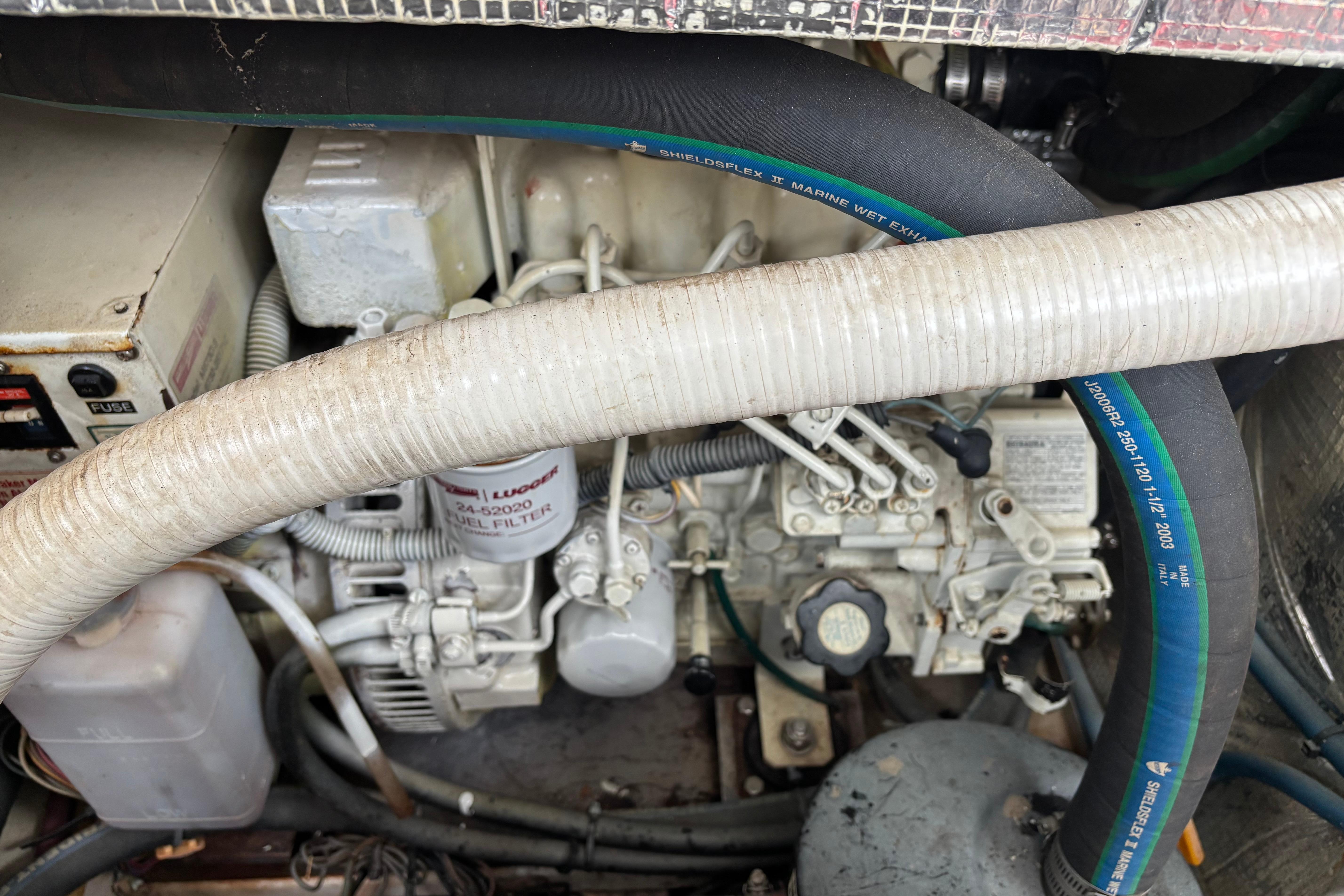 Engine compartment of a 2006 MJM 34z Express HT with visible hoses and components.
