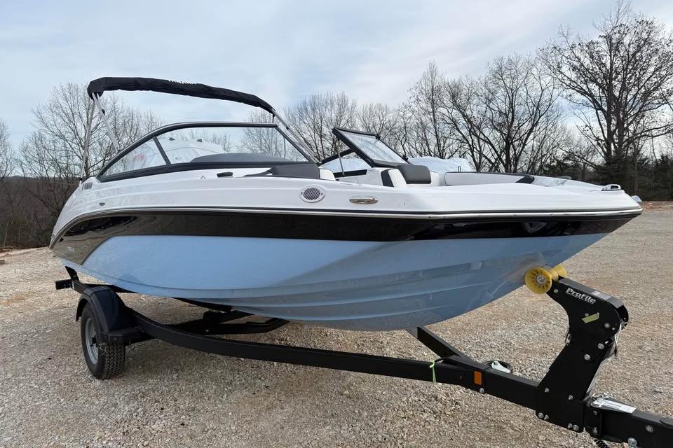2026 Yamaha Boats SX195 on trailer, parked outdoors, showcasing sleek design.