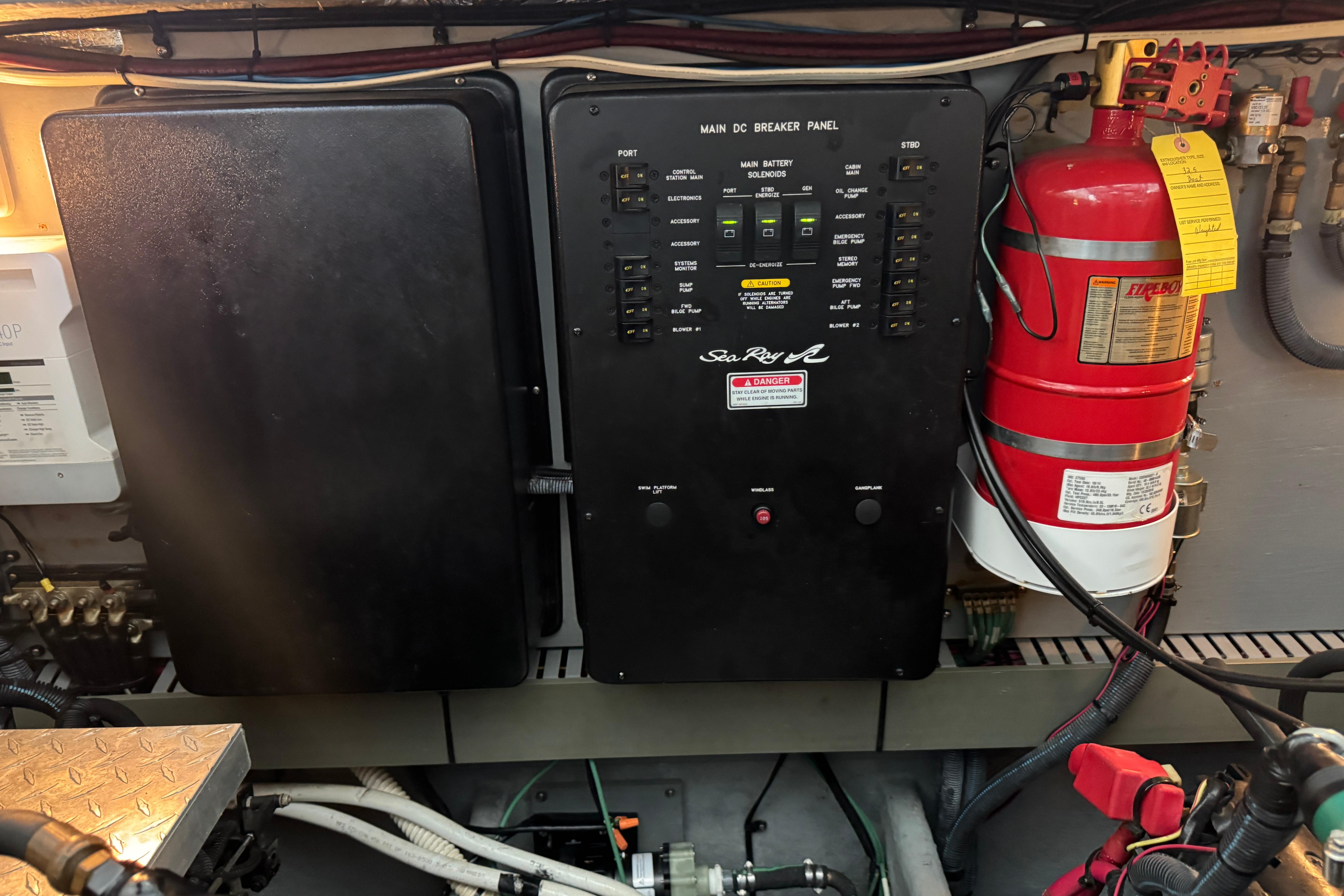 Electrical panel and fire extinguisher in 2001 Sea Ray 380 Sundancer boat engine room.