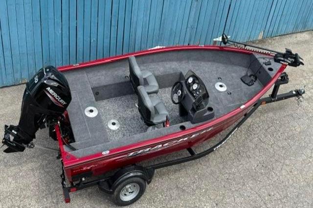2025 Tracker Super Guide V-16 SC fishing boat with Mercury engine, parked on trailer.