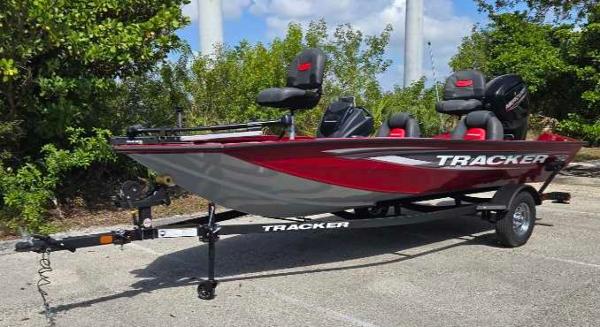 2025 Tracker Pro Team 175 boat, red and gray, parked on a trailer.