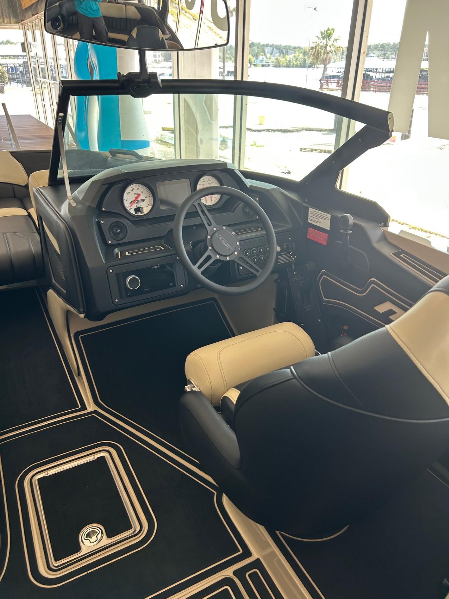 2024 MB F22 Tomcat boat interior with steering wheel and dashboard controls.