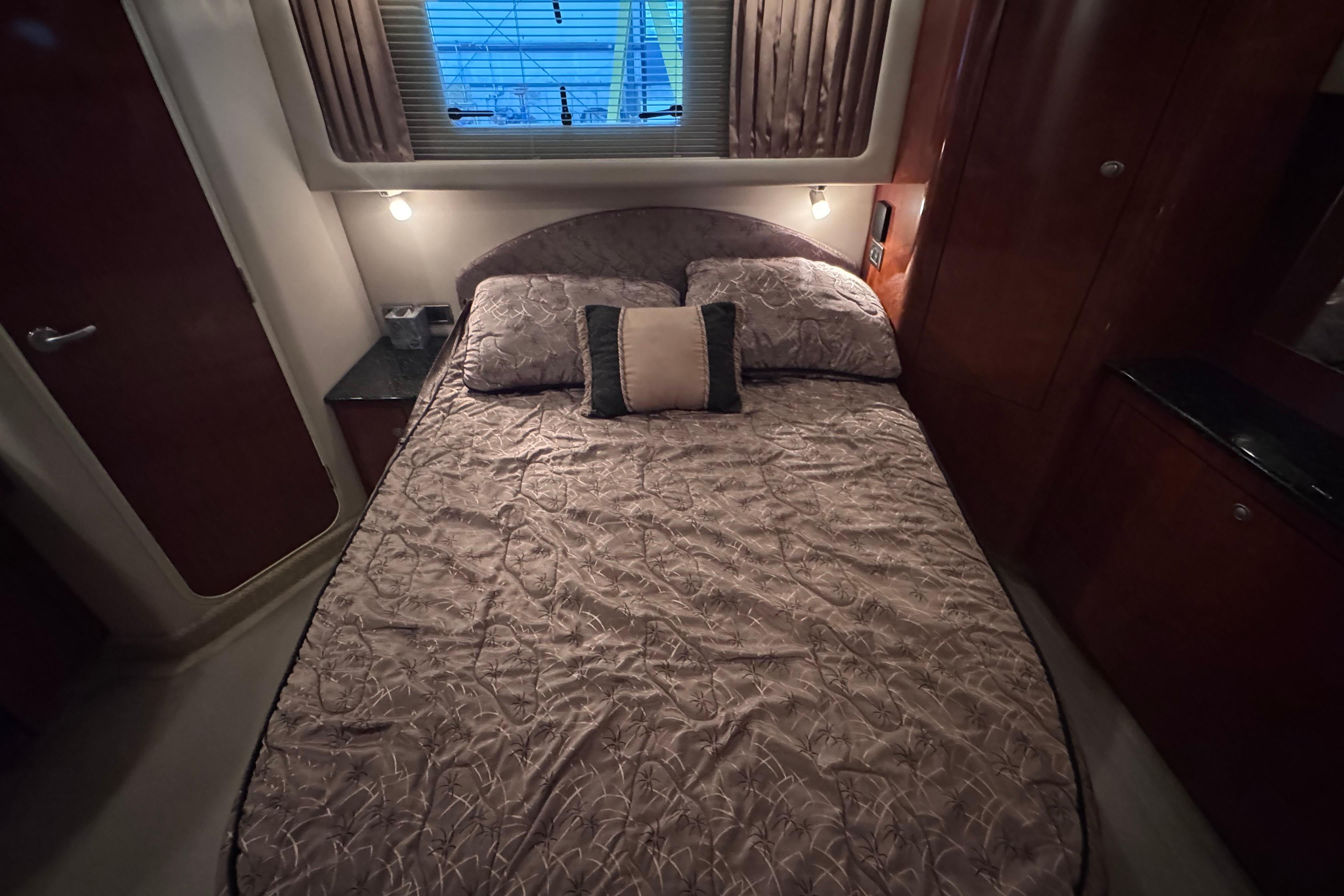 Luxurious bedroom interior of 2004 Sea Ray 390 Motor Yacht with elegant bedding.