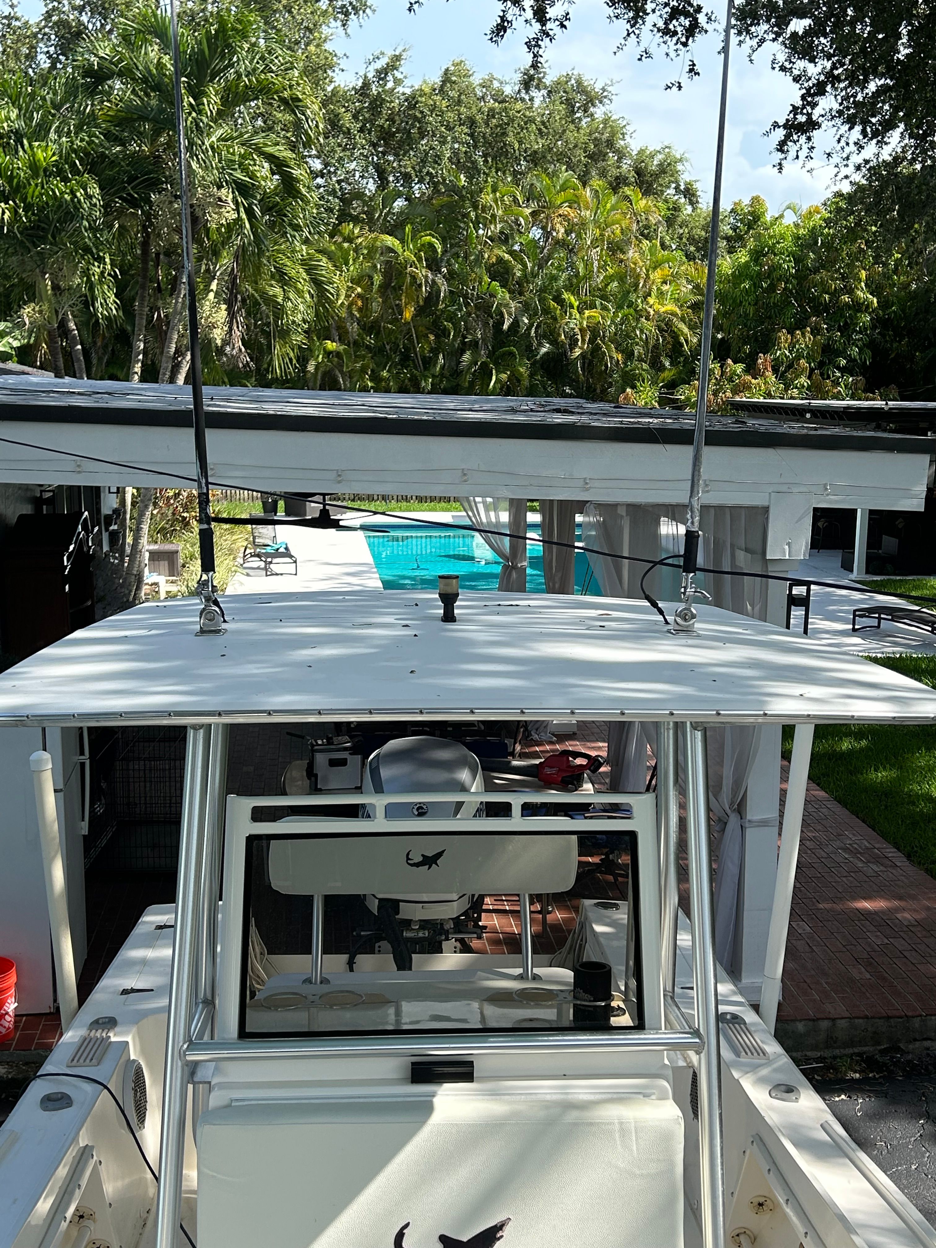 1992 Mako 221 boat parked in a backyard with pool.