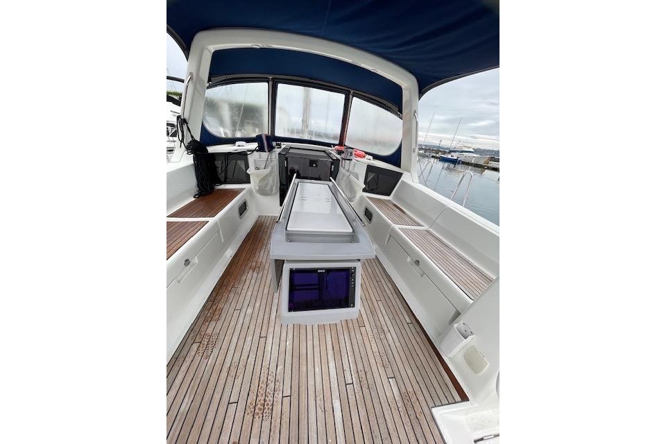 2018 Beneteau Oceanis 45 yacht cockpit with teak flooring and blue canopy.