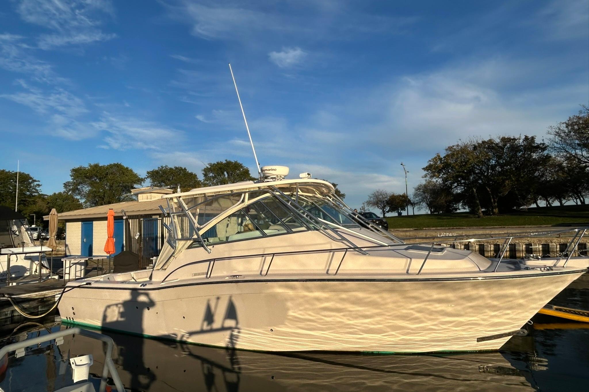 2007 Grady-White Express 360 boat docked under a clear blue sky.