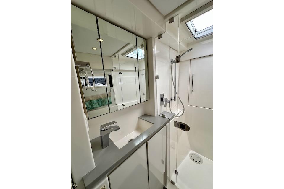 Modern bathroom in a 2017 Leopard 40 yacht with sleek fixtures and mirrored cabinets.