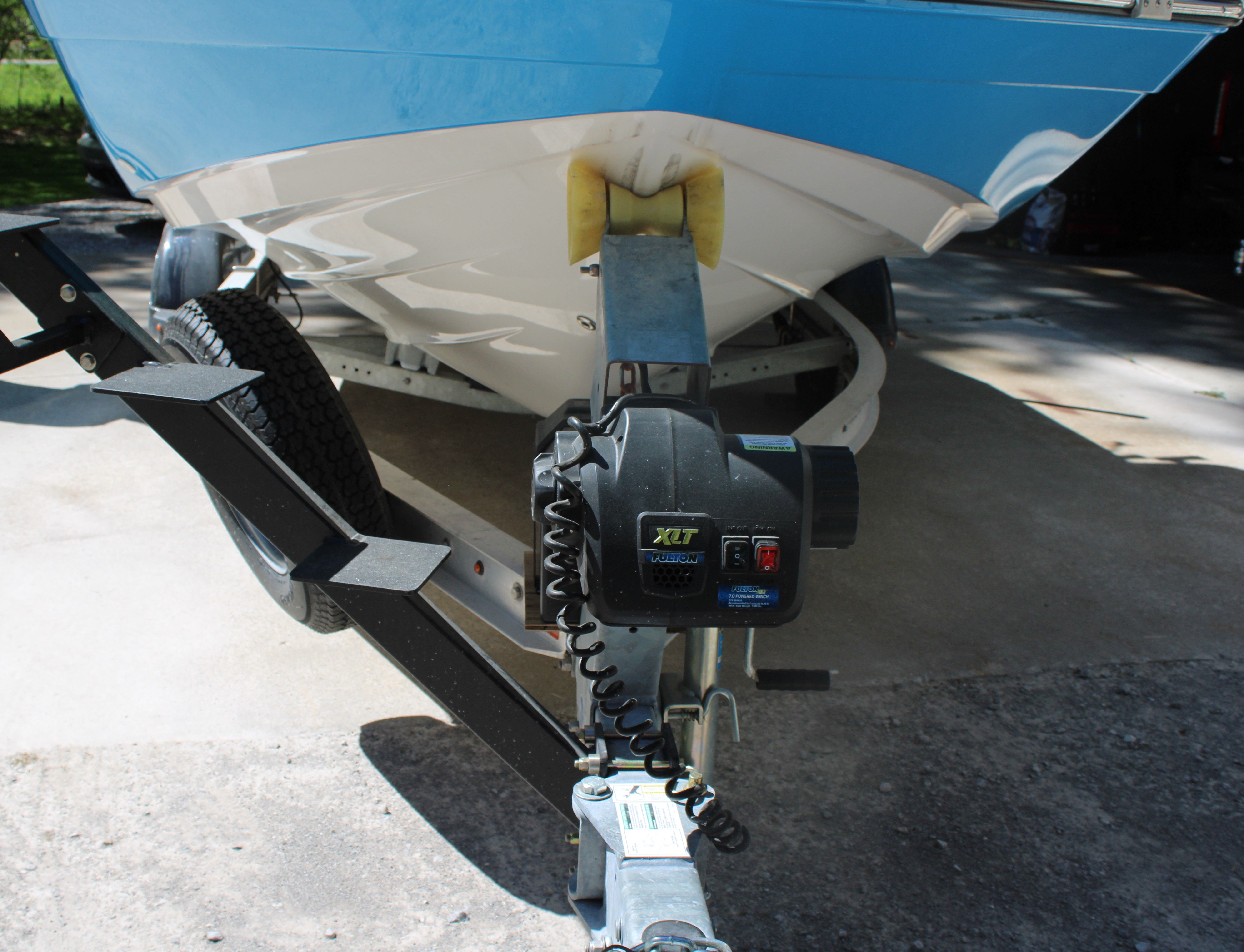 A Yamaha 190 FSH Sport boat on a trailer, ready for transport.