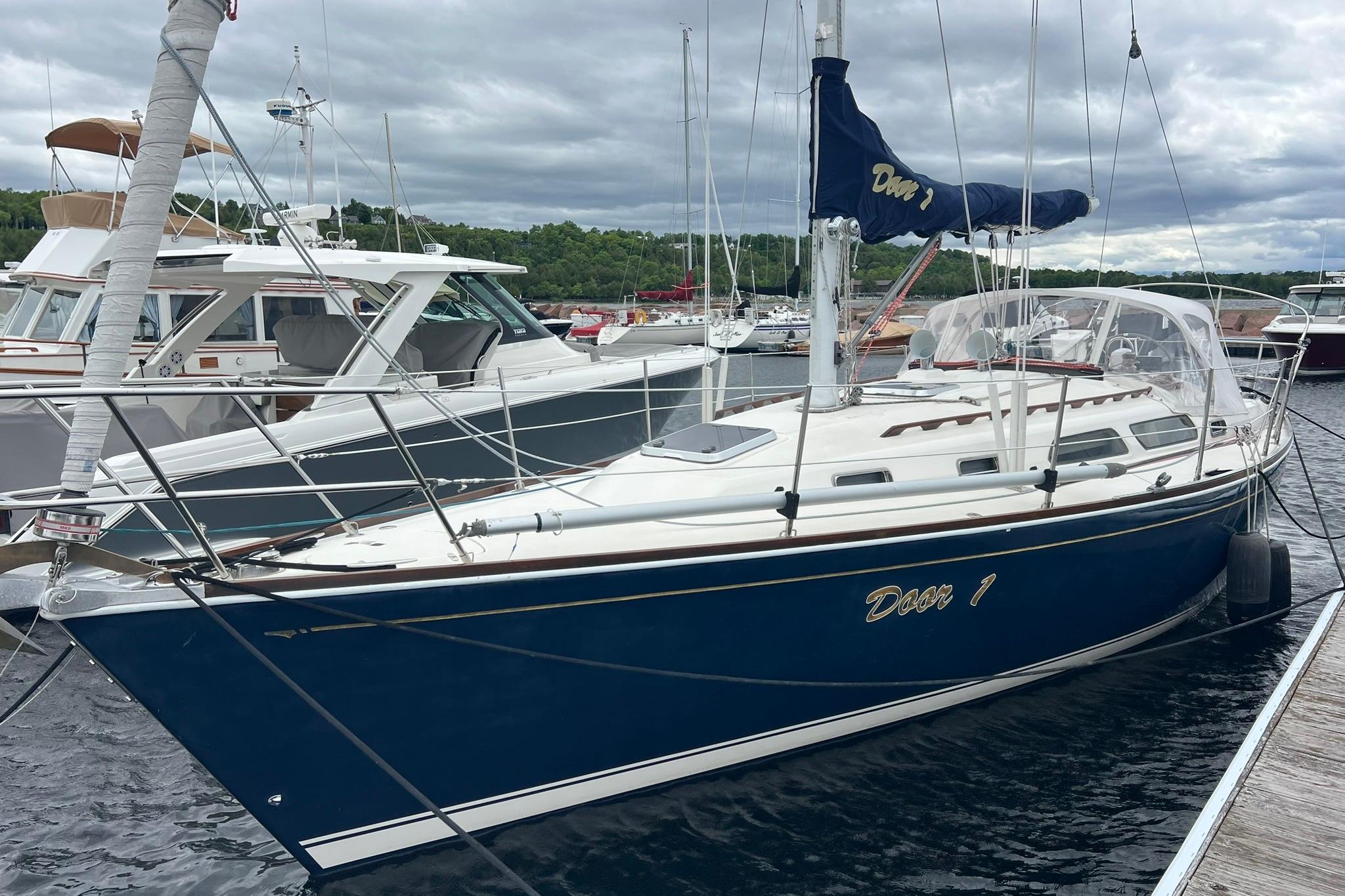 1998 Sabre 362 sailboat docked in marina, featuring blue hull and white deck.