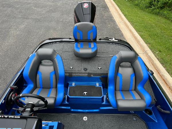 2025 Nitro Z19 Pro boat interior with blue and gray seating, steering wheel, and motor.