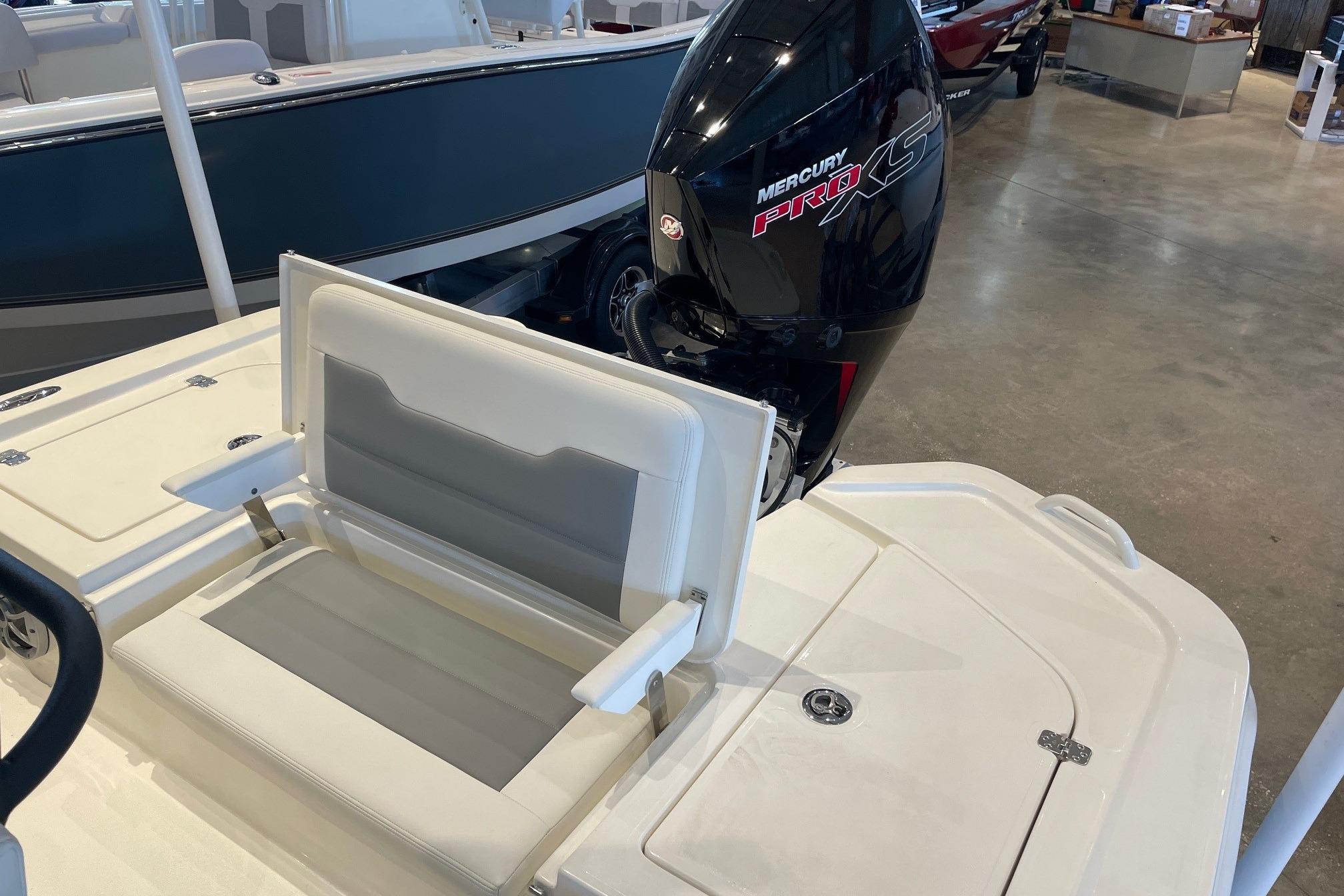 2026 Mako 24 APEX boat with Mercury Pro XS engine, featuring a comfortable seating area.