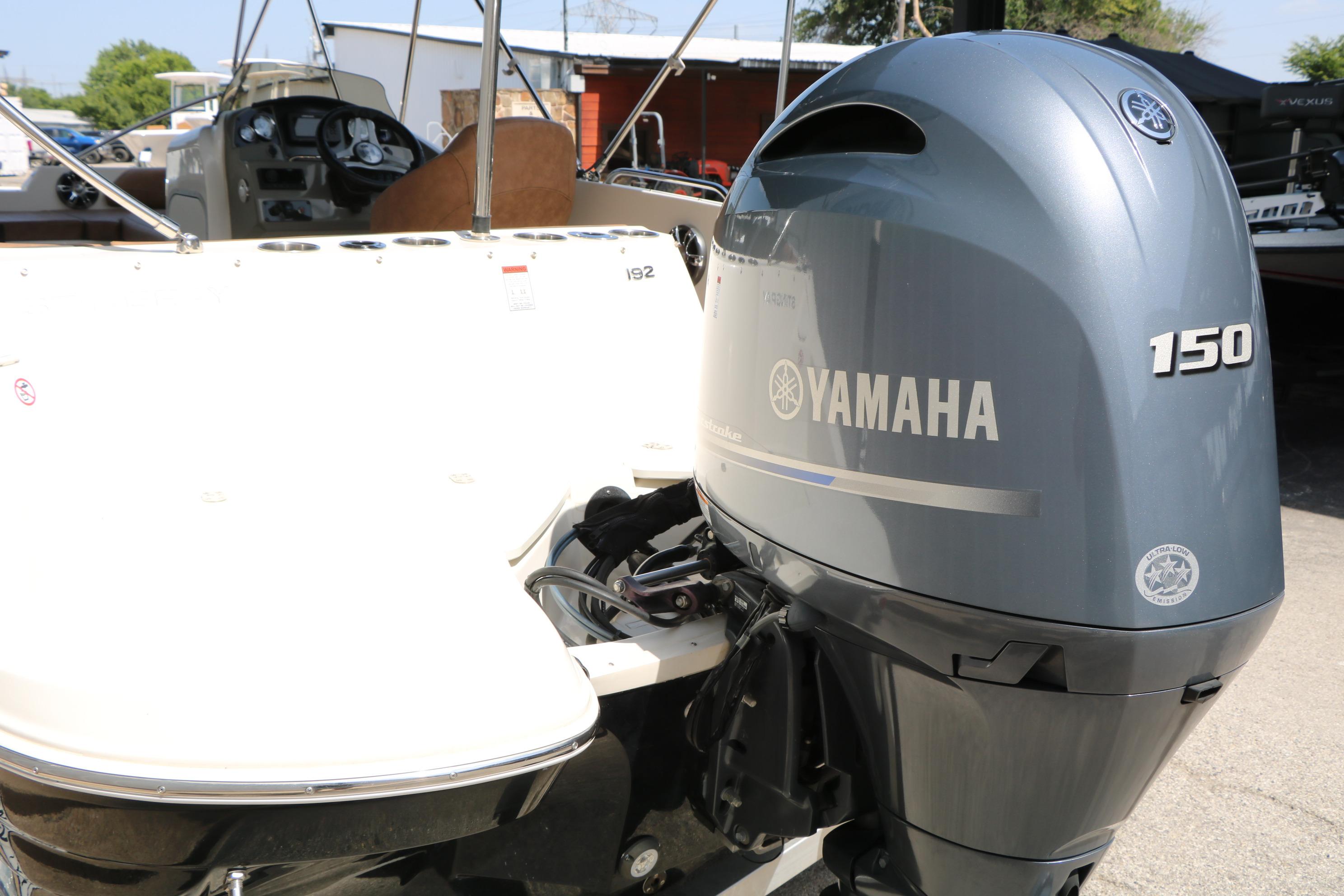 2022 Stingray 192 SC boat with Yamaha 150 outboard motor, docked outdoors.