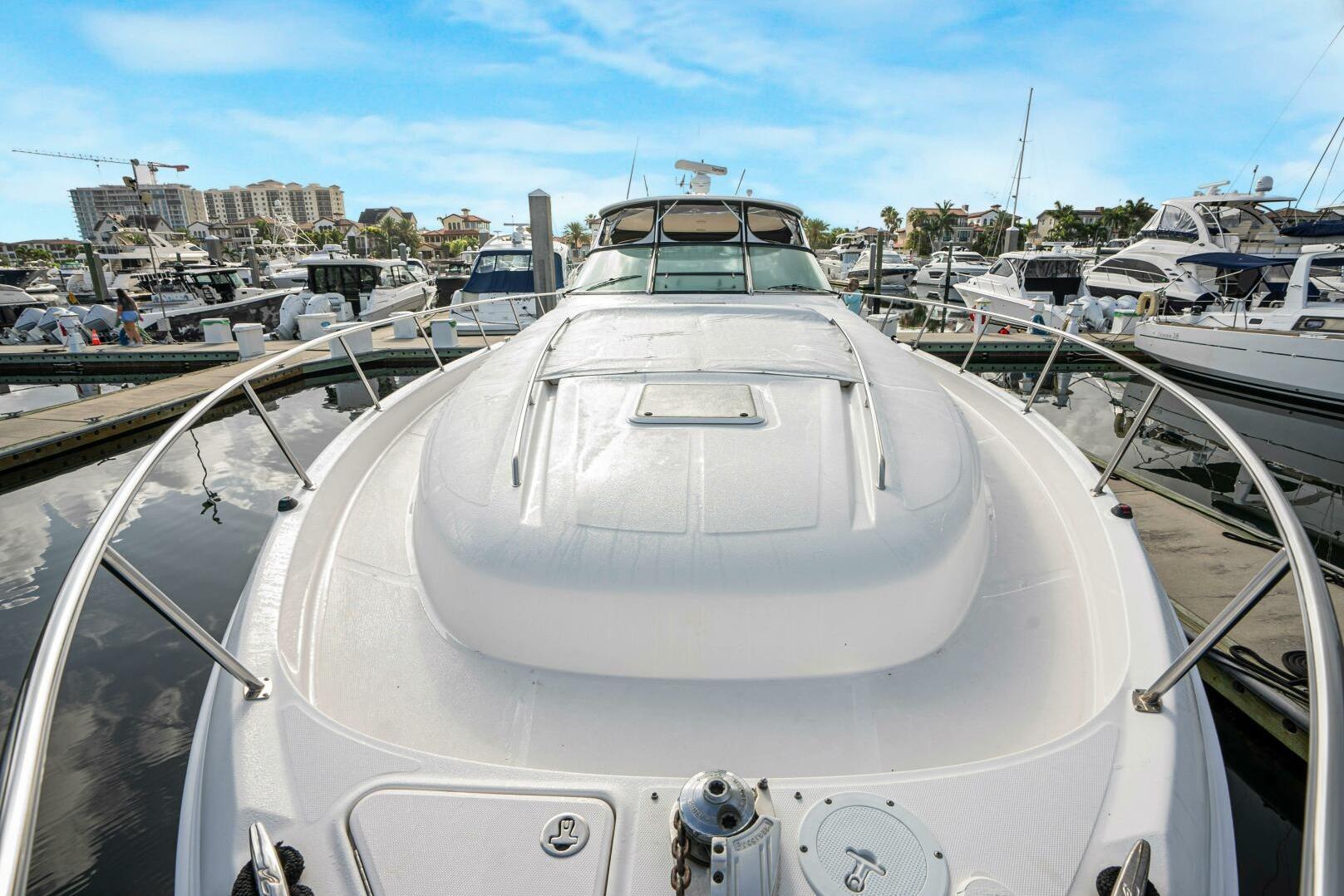 2003 Sea Ray Sundancer 460 yacht docked at a marina, surrounded by other boats.