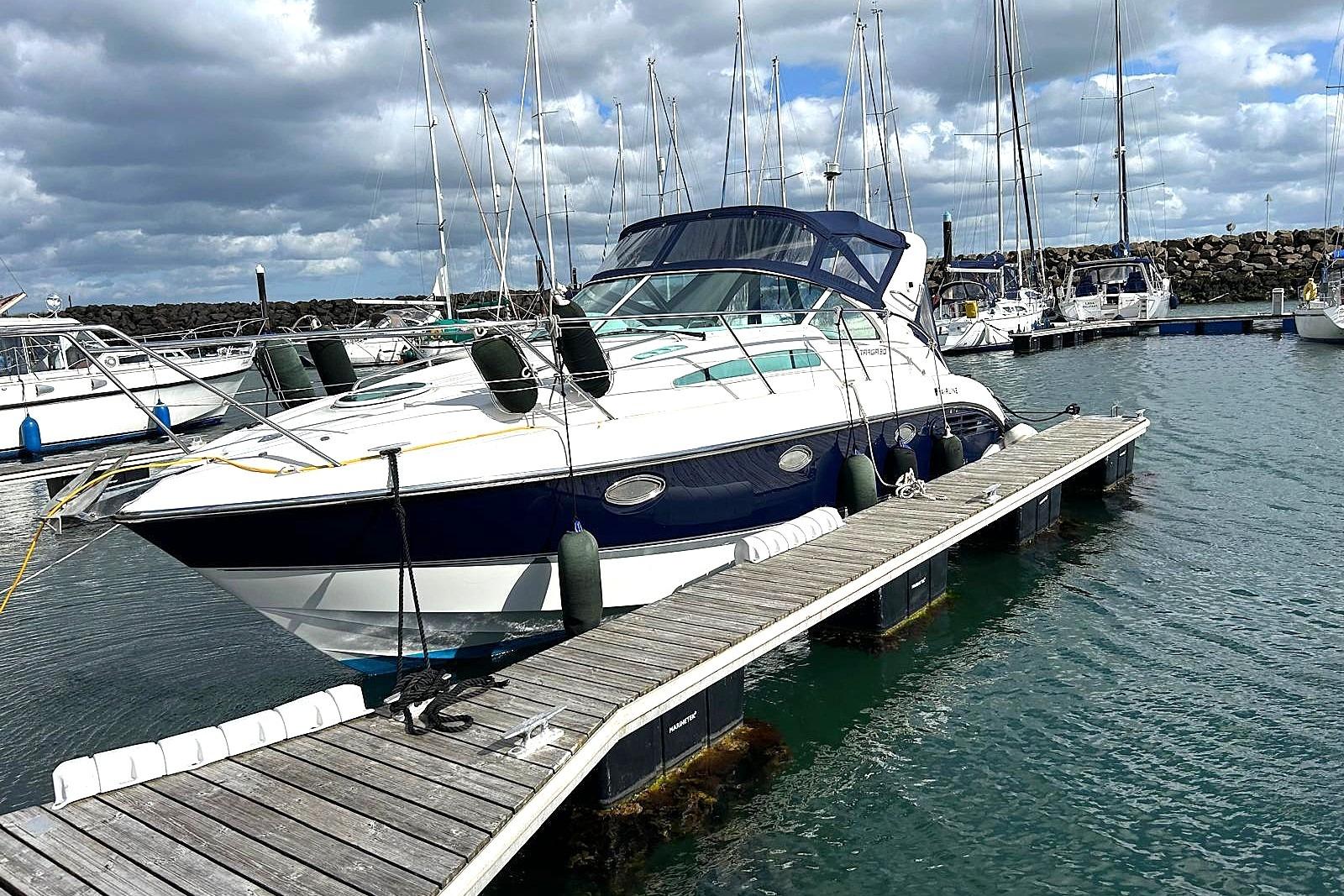 2000 Fairline Targa 30 yacht docked at marina under cloudy sky.