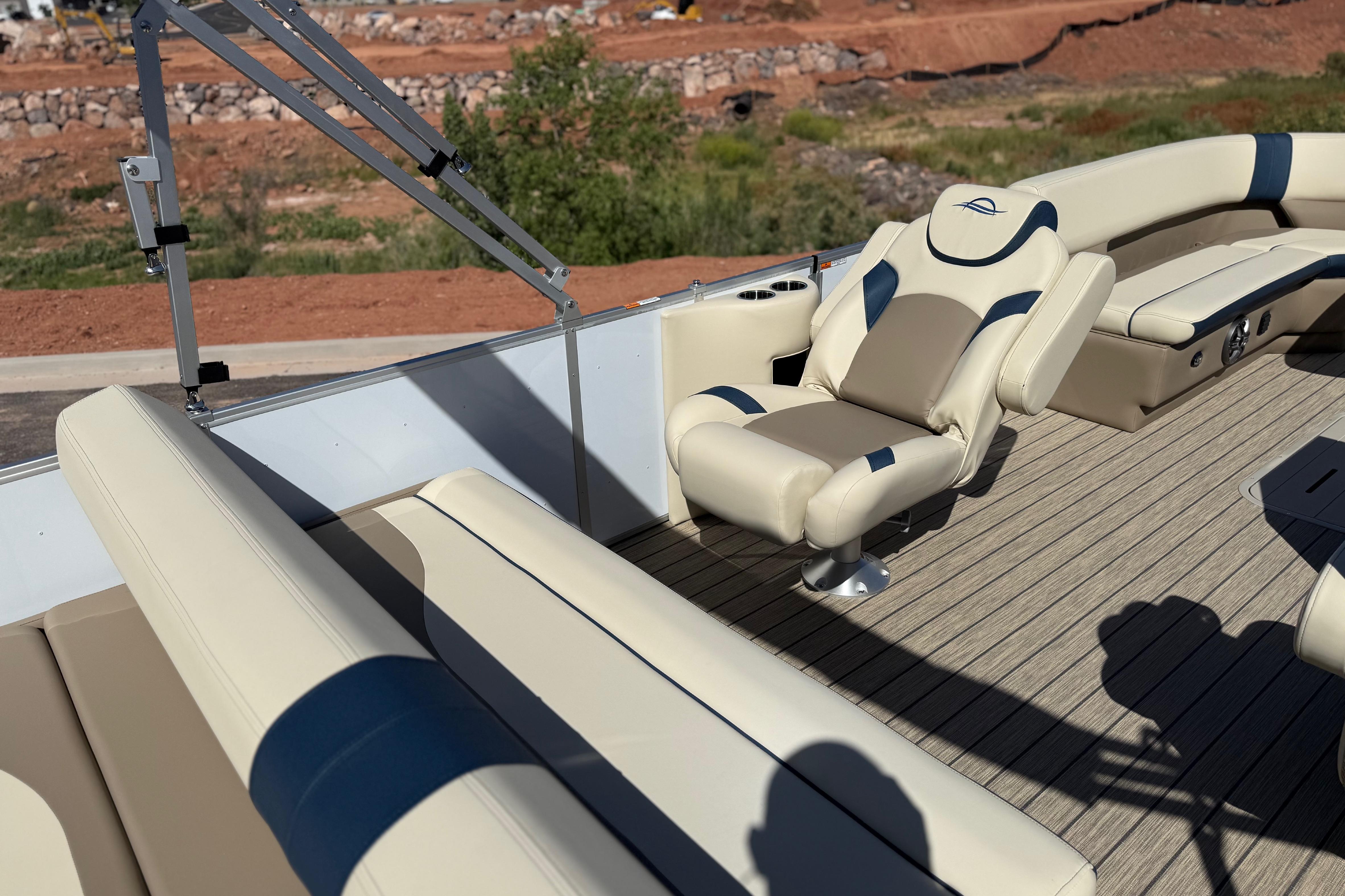 Luxurious seating on 2026 SunCatcher Select 322SL pontoon boat, featuring beige and blue upholstery.