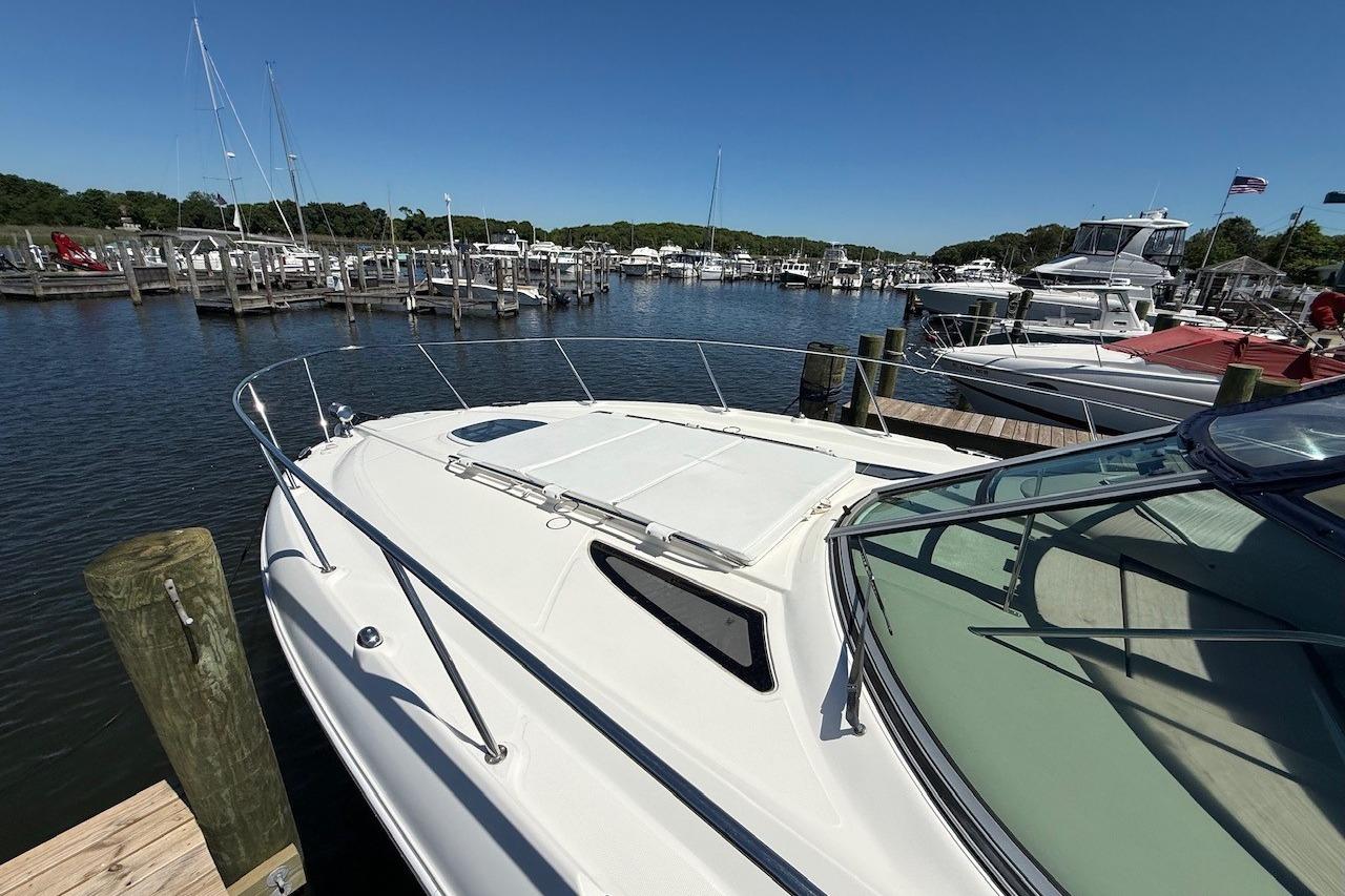 2008 Sea Ray Sundancer 330 docked at a marina under clear blue skies.