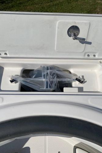 2024 Robalo R222 Center Console storage compartment with a wrapped item.