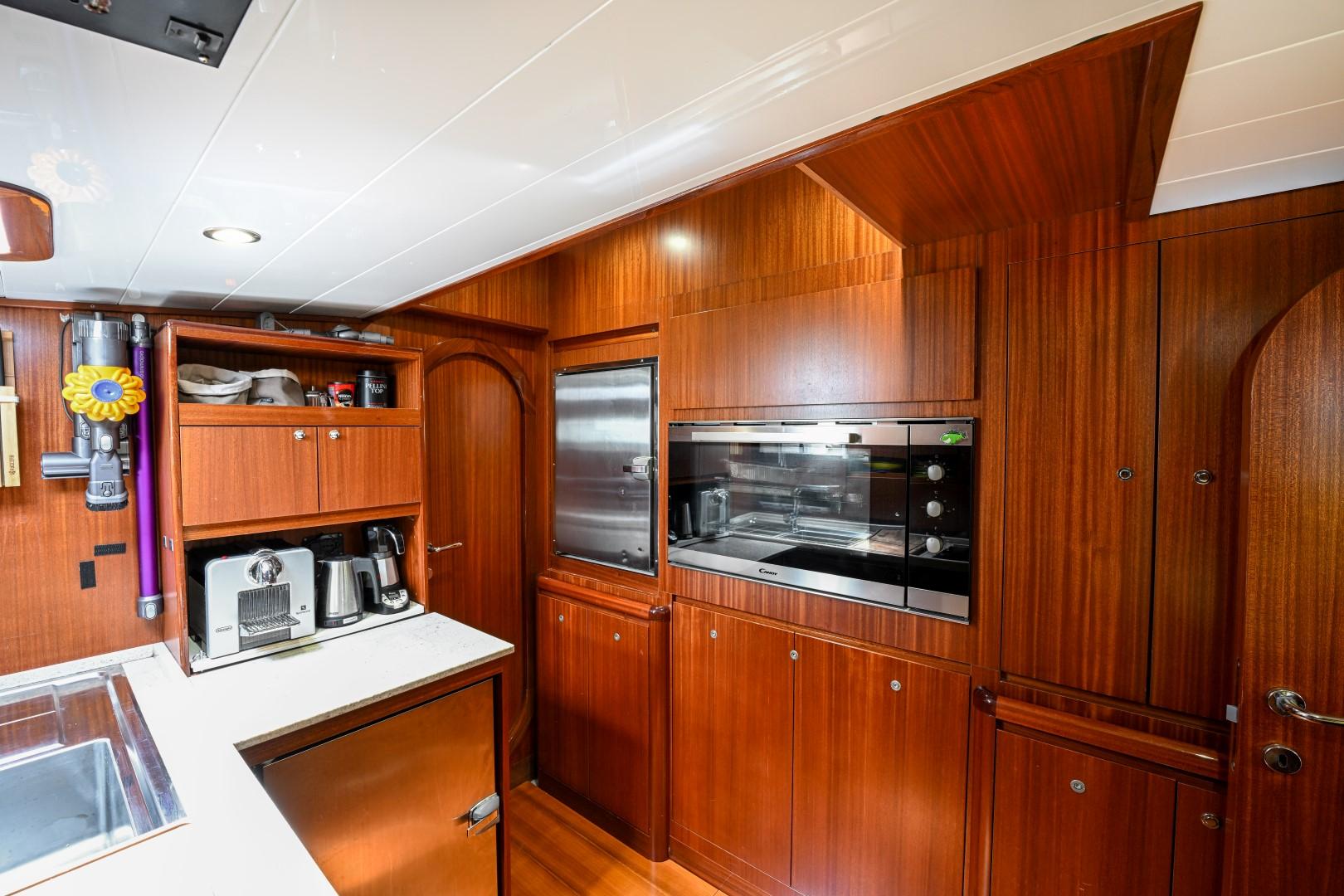 Luxurious wooden kitchen interior of 1978 Schooner 22m Cantiere Stain yacht.