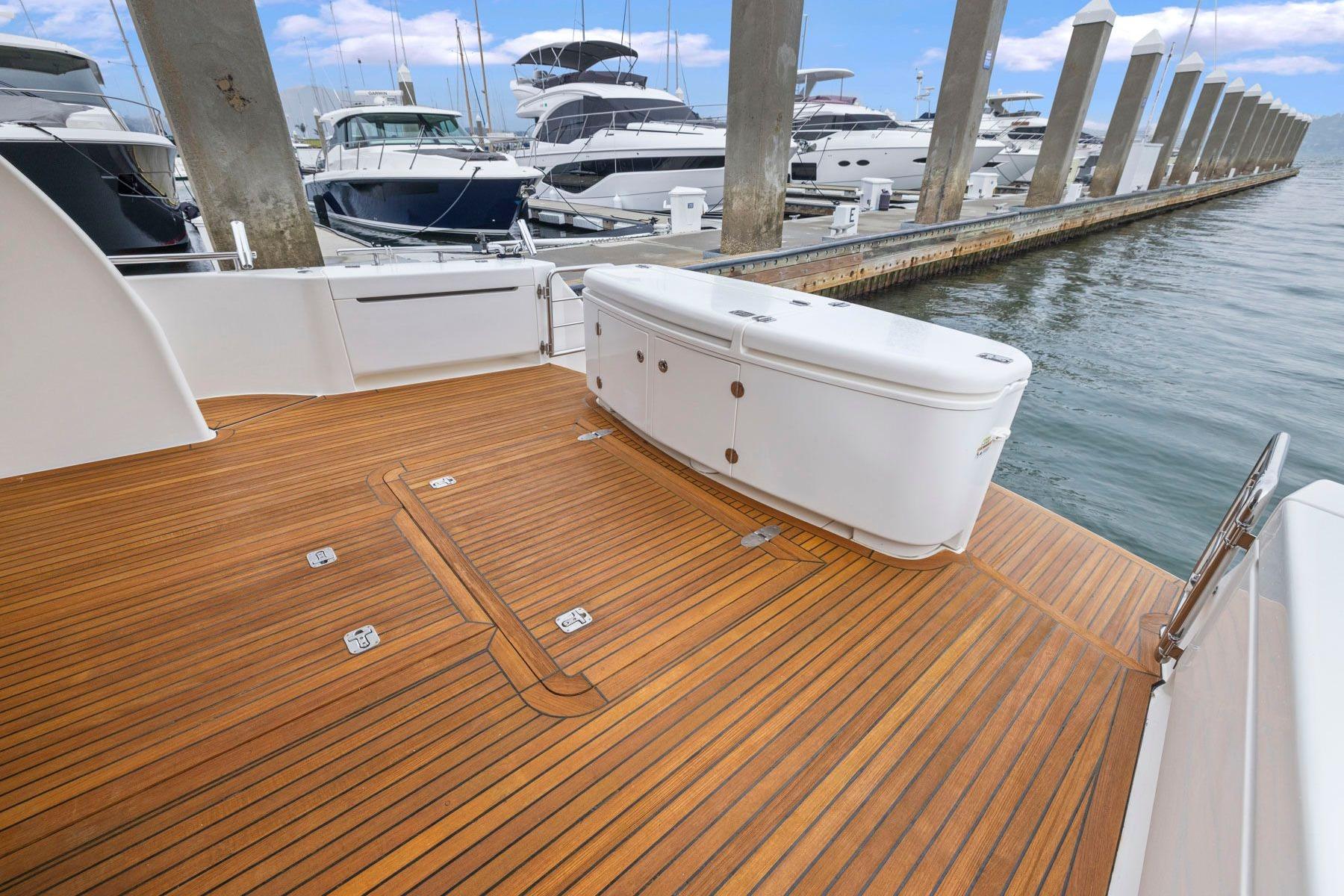 Luxurious 2014 Maritimo M50 yacht with elegant teak deck at marina.