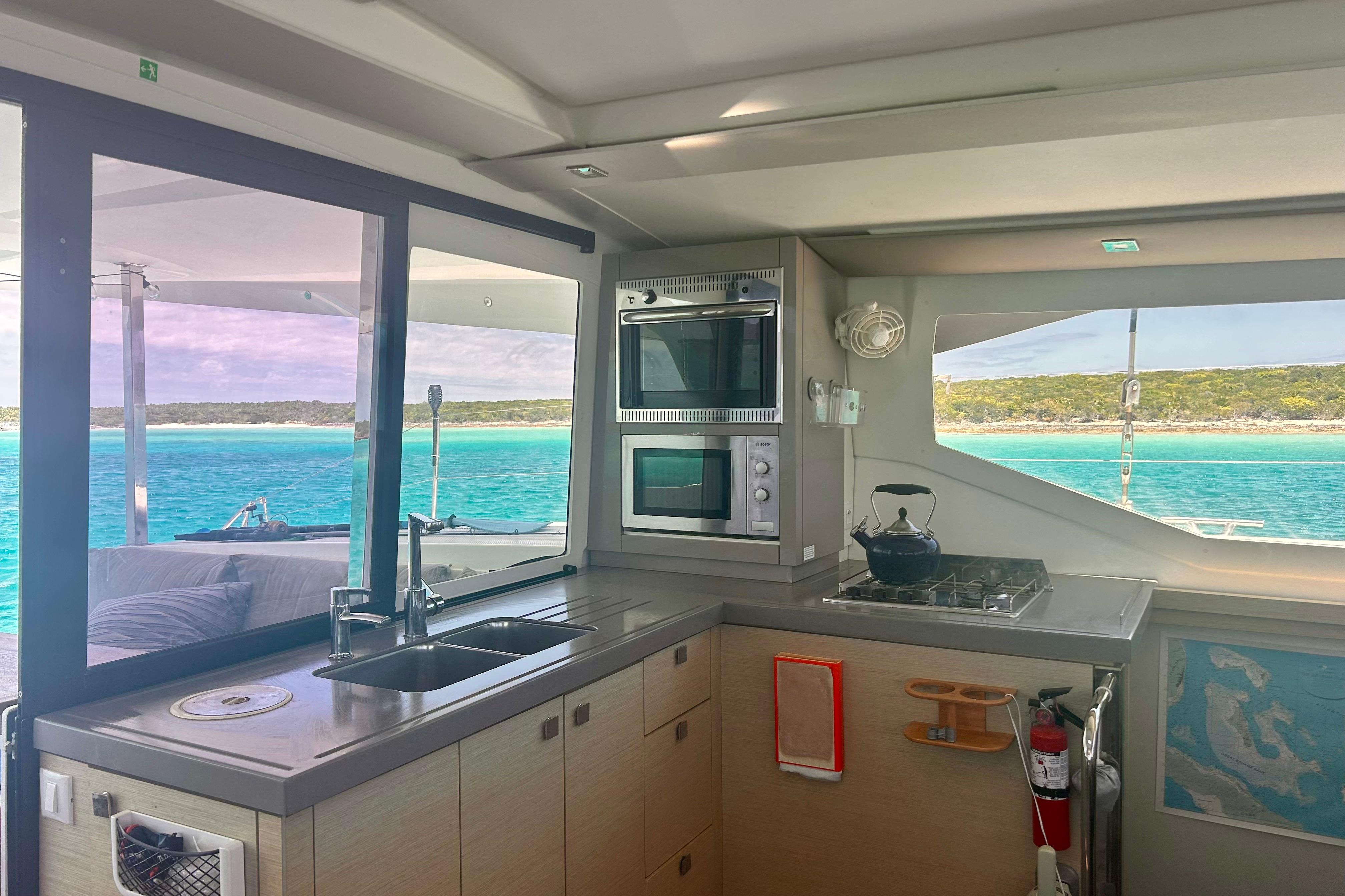 Interior of 2018 Fountaine Pajot Lucia 40 yacht with modern kitchen and ocean view.