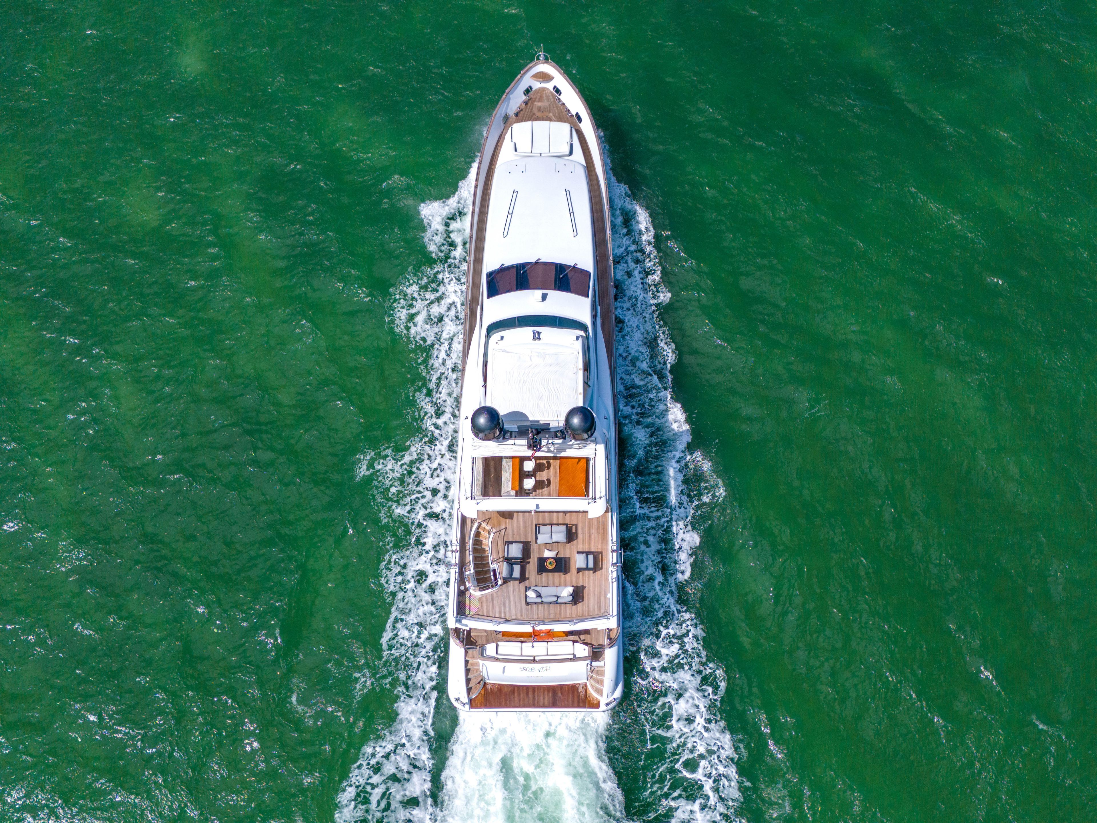 Aerial view of 2012 Azimut Grande 105 yacht cruising on green water.