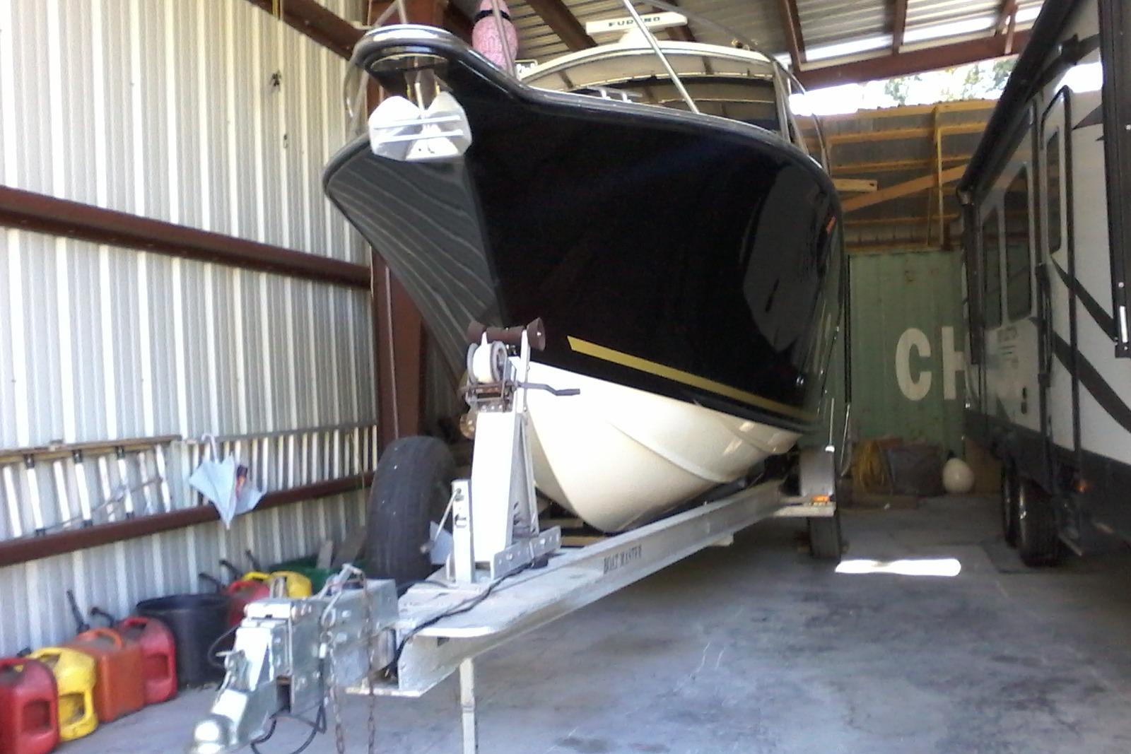 2002 Albemarle 265 Express Fisherman boat on trailer in storage shed.