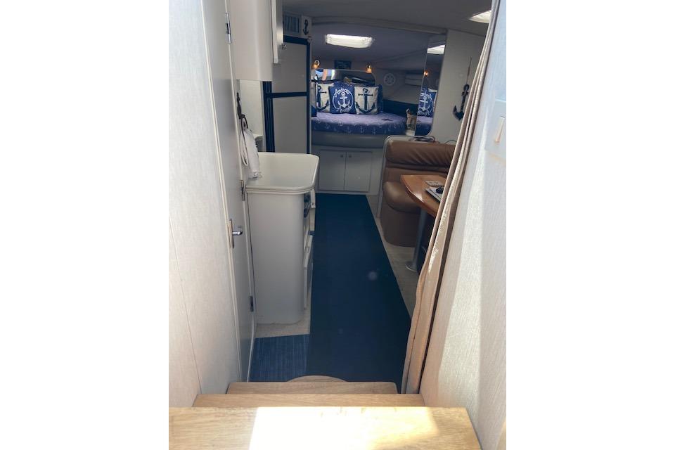Interior view of 1994 Cruisers Yachts 3675 Esprit, featuring cozy cabin and seating area.