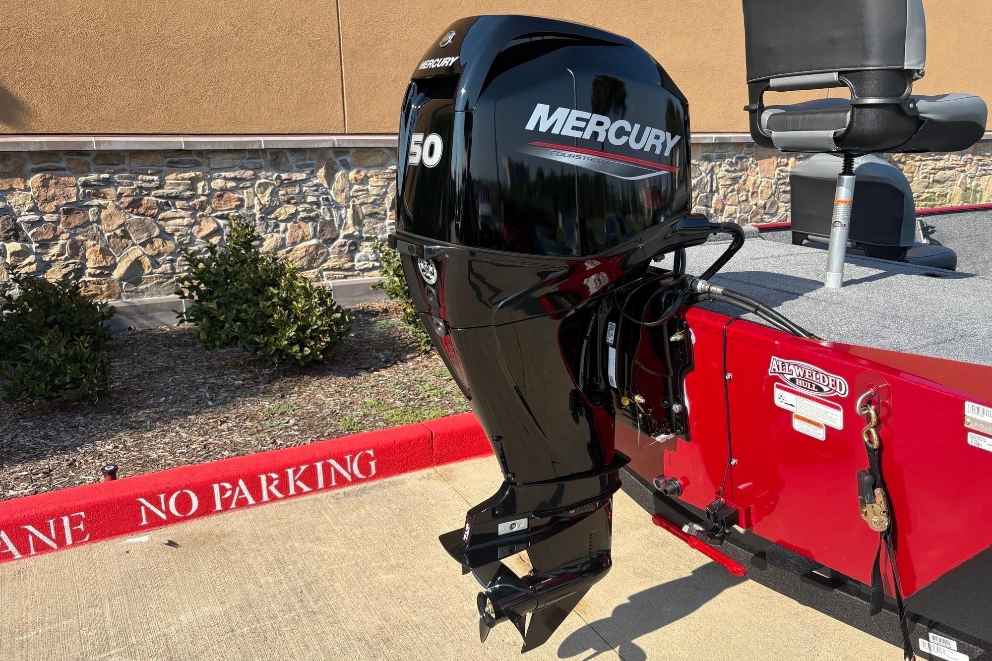 2026 Tracker Bass Tracker Classic XL with Mercury 50 outboard motor, parked near "No Parking" zone.