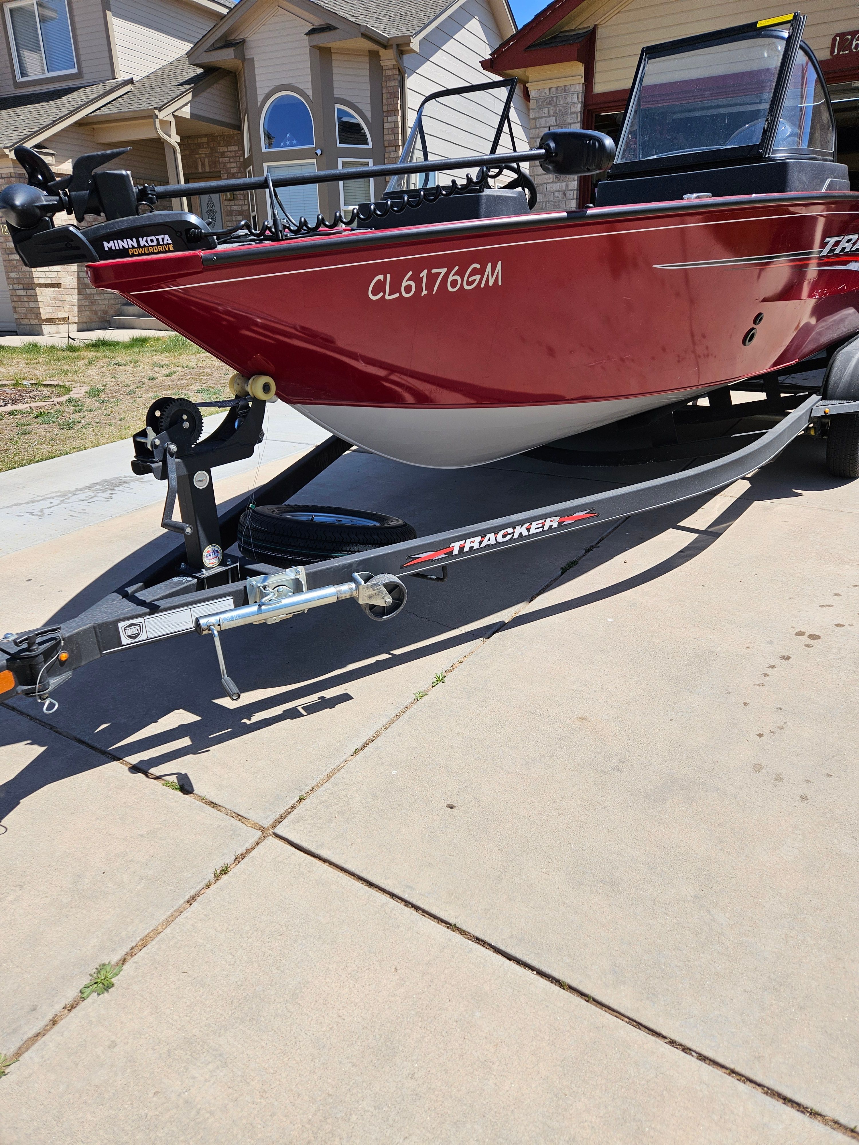 2021 Tracker Pro Guide V-175 WT boat on trailer in driveway.
