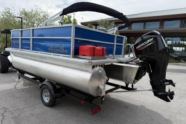 2026 Sun Tracker Party Barge 16 DLX pontoon boat on trailer with Mercury outboard motor.