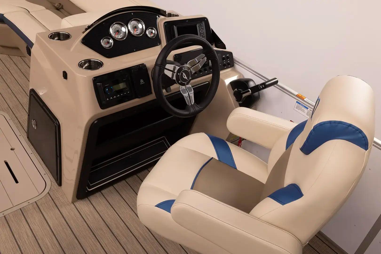 Manufacturer Provided Image: Captain's seat and helm of 2026 SunCatcher Select 322RC boat, featuring modern controls and gauges.