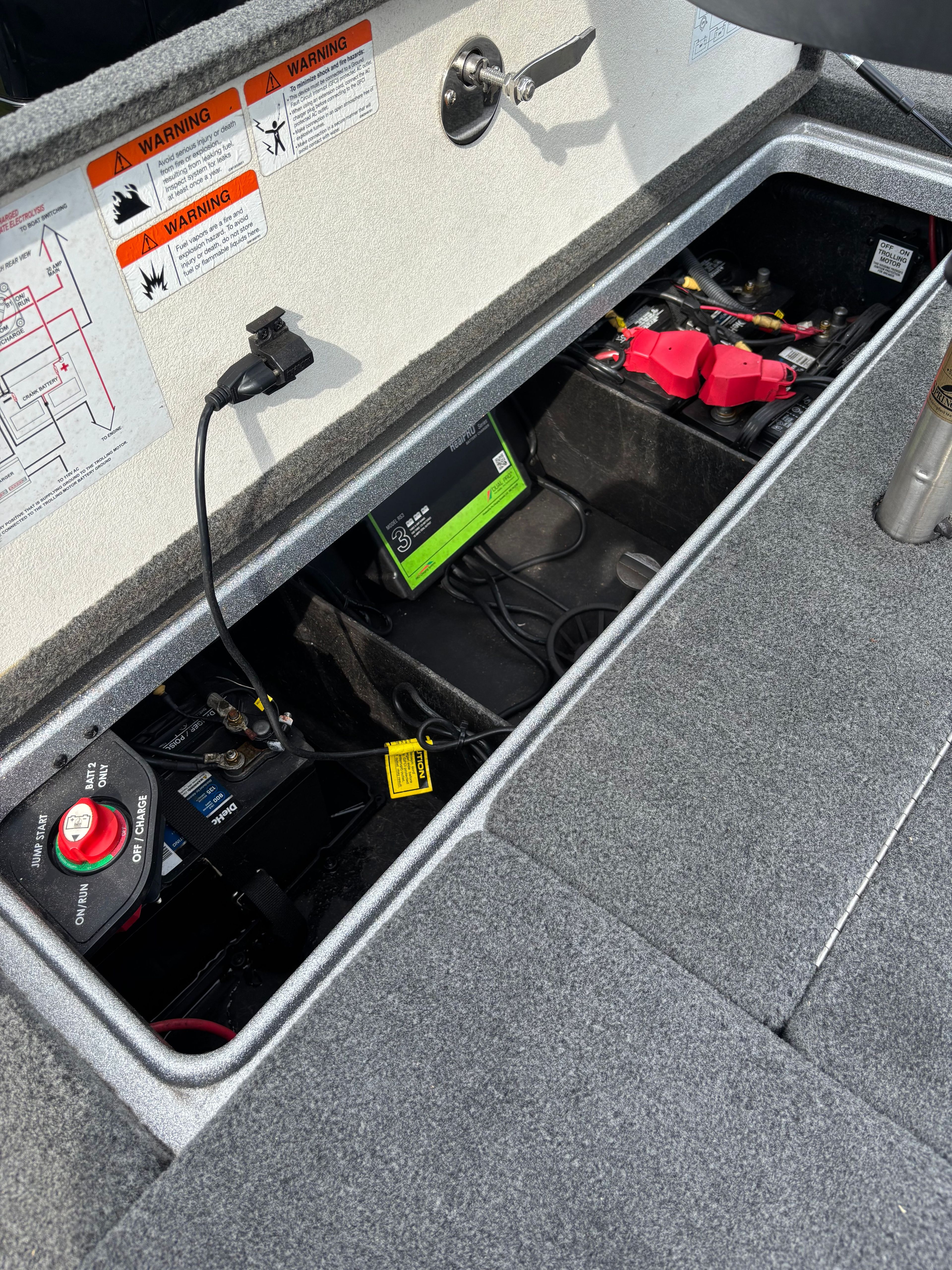 View of a Ranger Z 185 boat's battery compartment with cables and connections.