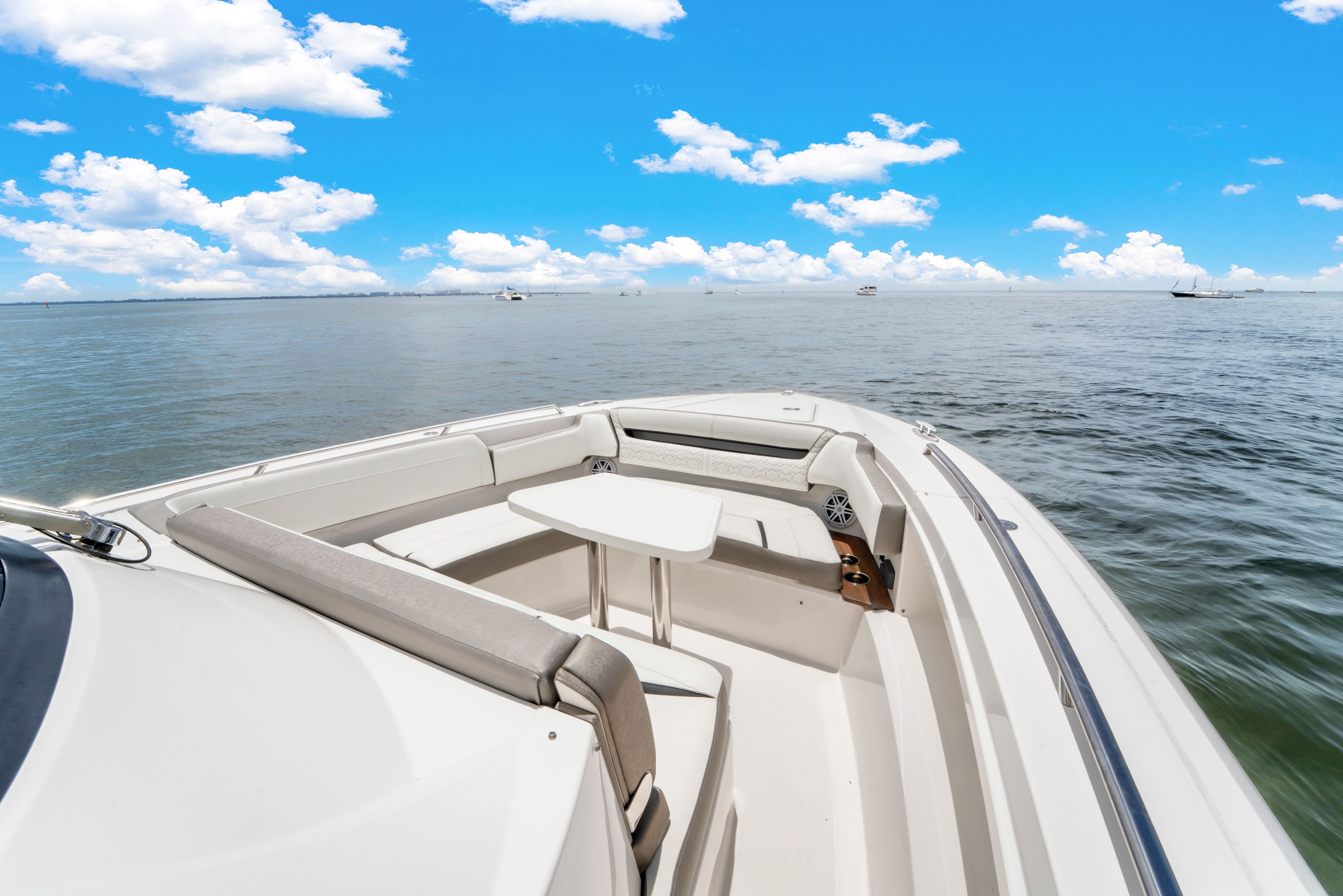 The image shows the deck of a 2023 Tiara Yachts 38 LS on calm water.