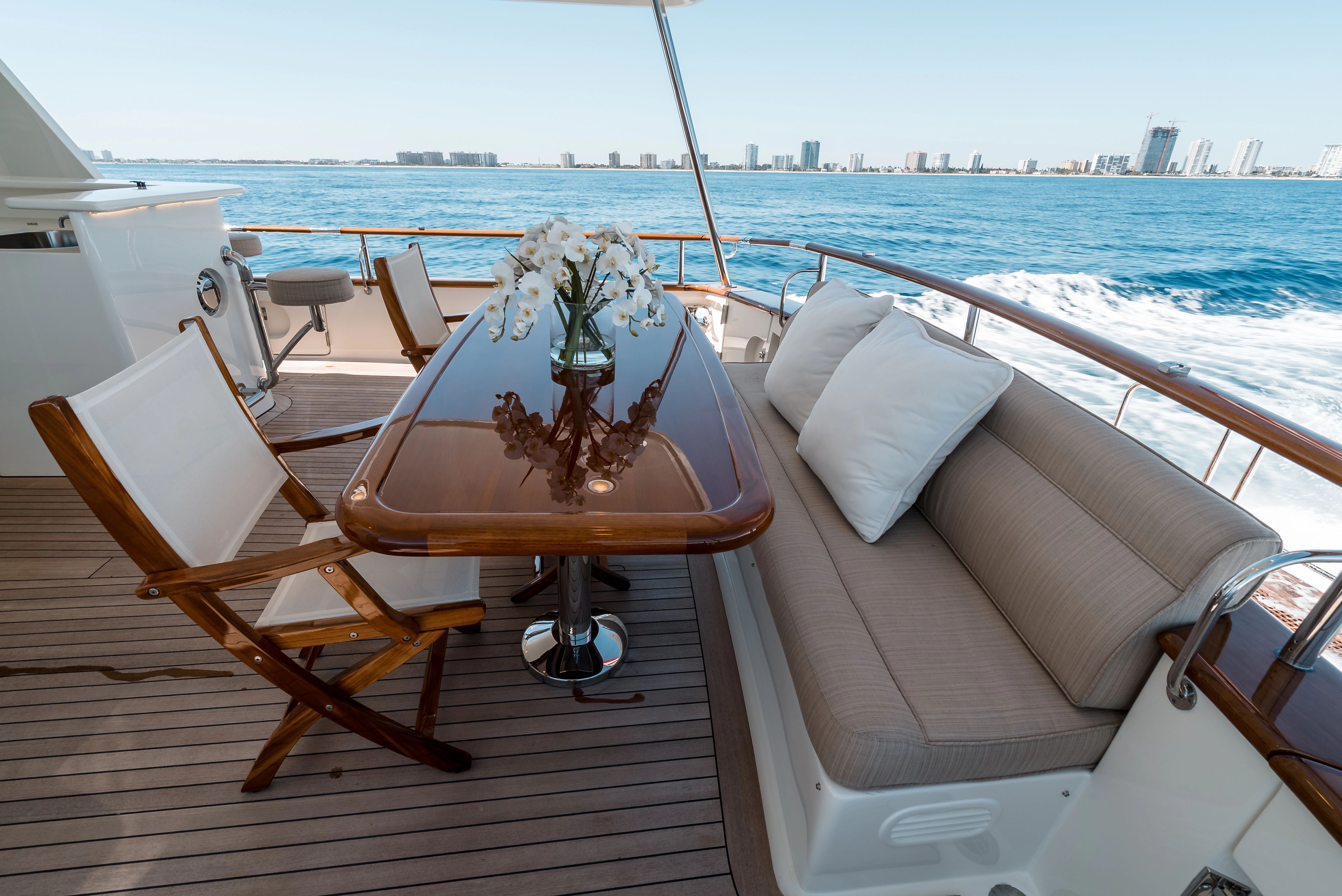 Luxurious Marlow Explorer 2011 yacht deck with table and ocean view.