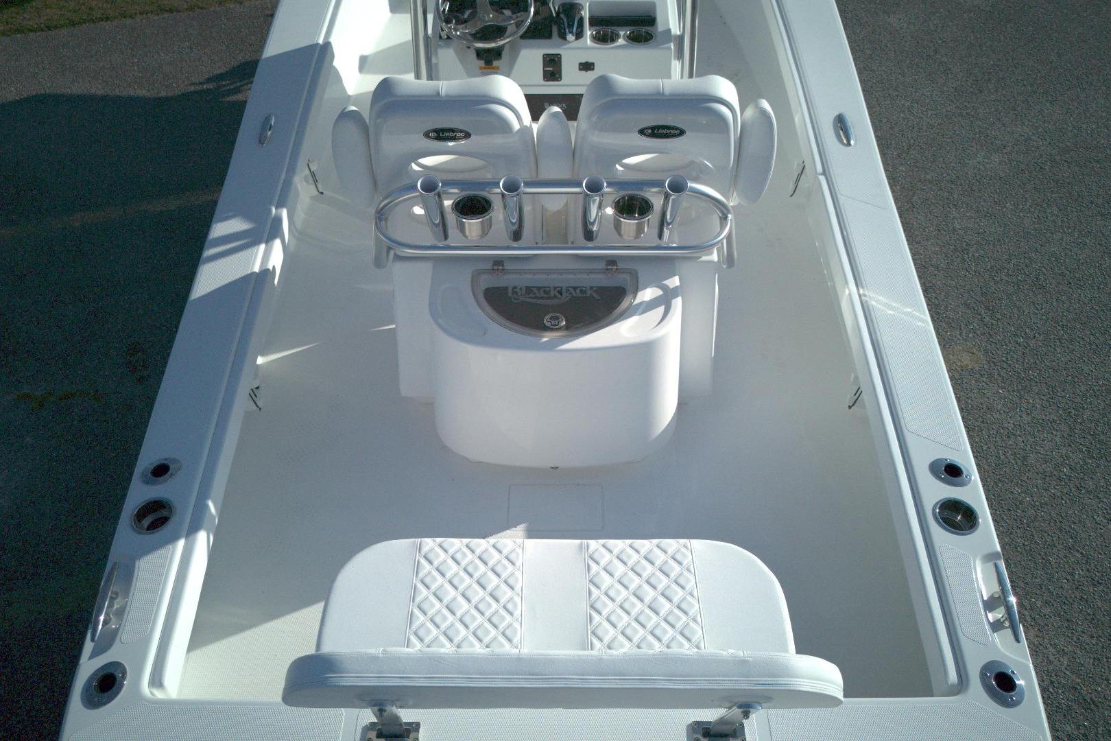 2026 BlackJack 256 Coastal boat interior with white seating and fishing rod holders.