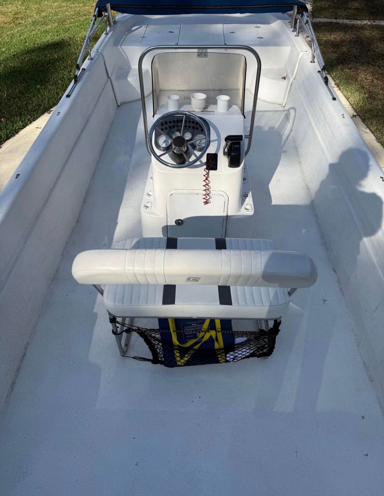 The image shows the cockpit of a 2011 Carolina Skiff 258 DLV with a helm station.