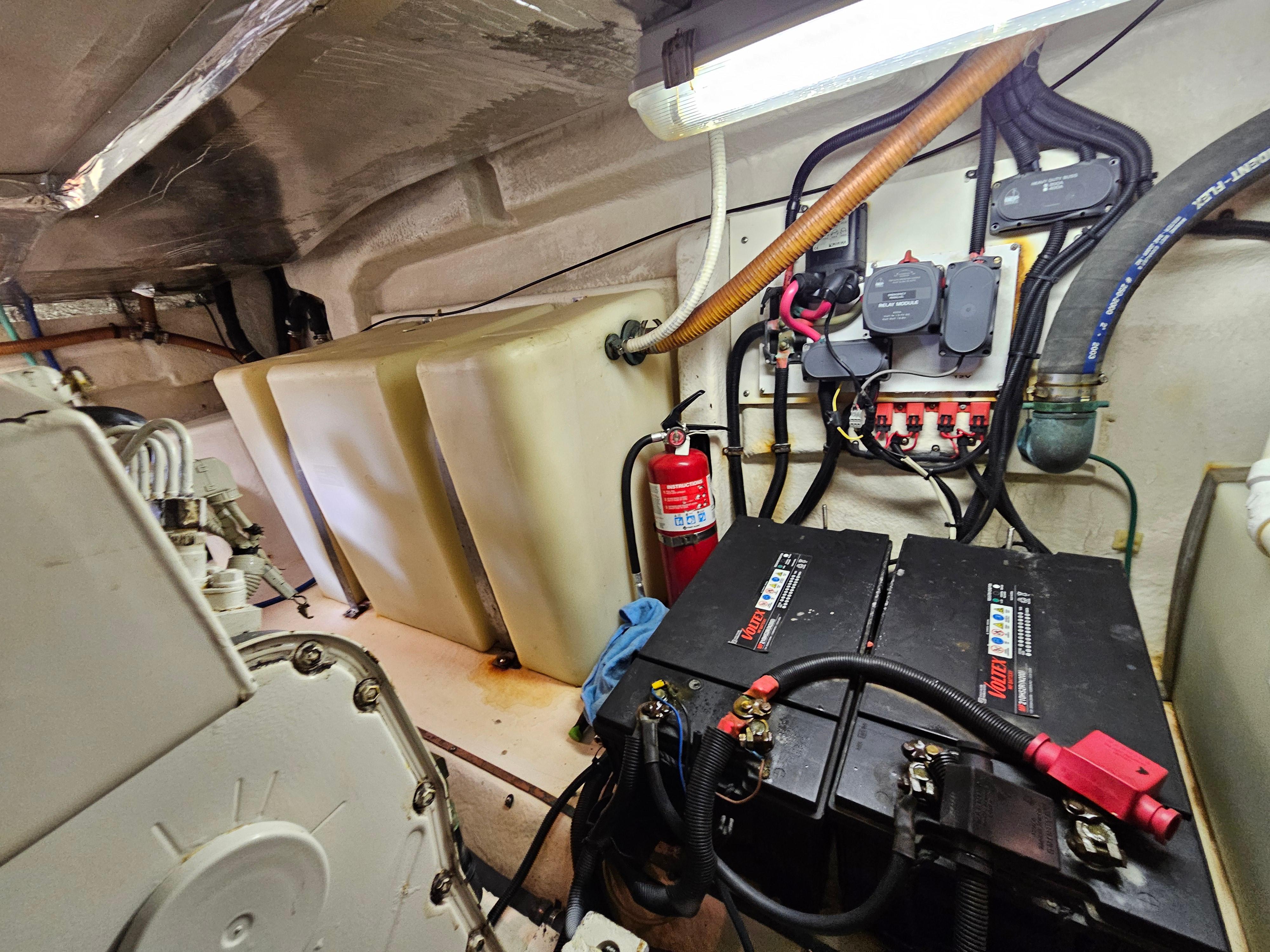 Engine room of 2004 Riviera 42 Convertible with batteries and fire extinguisher.